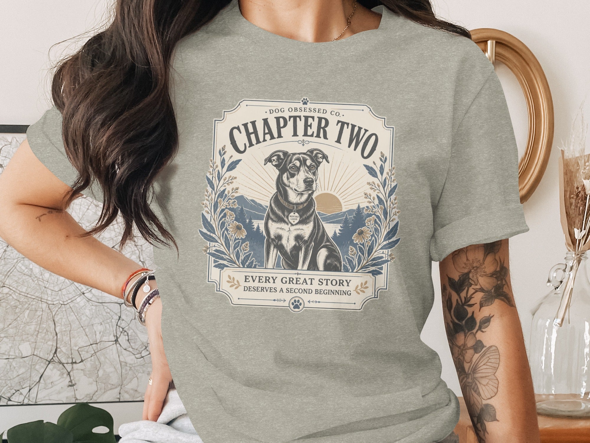 Grey t-shirt with graphic: "Chapter Two", a dog, and "Every great story deserves a second beginning."