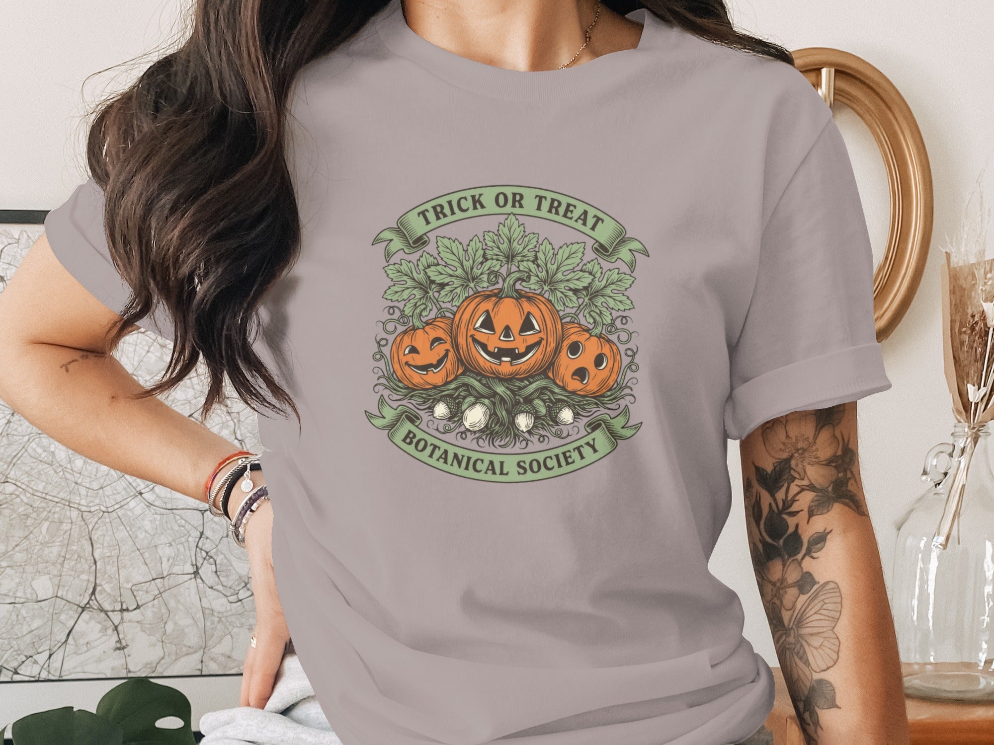 T-shirt with pumpkins, leaves, and text "TRICK OR TREAT BOTANICAL SOCIETY".