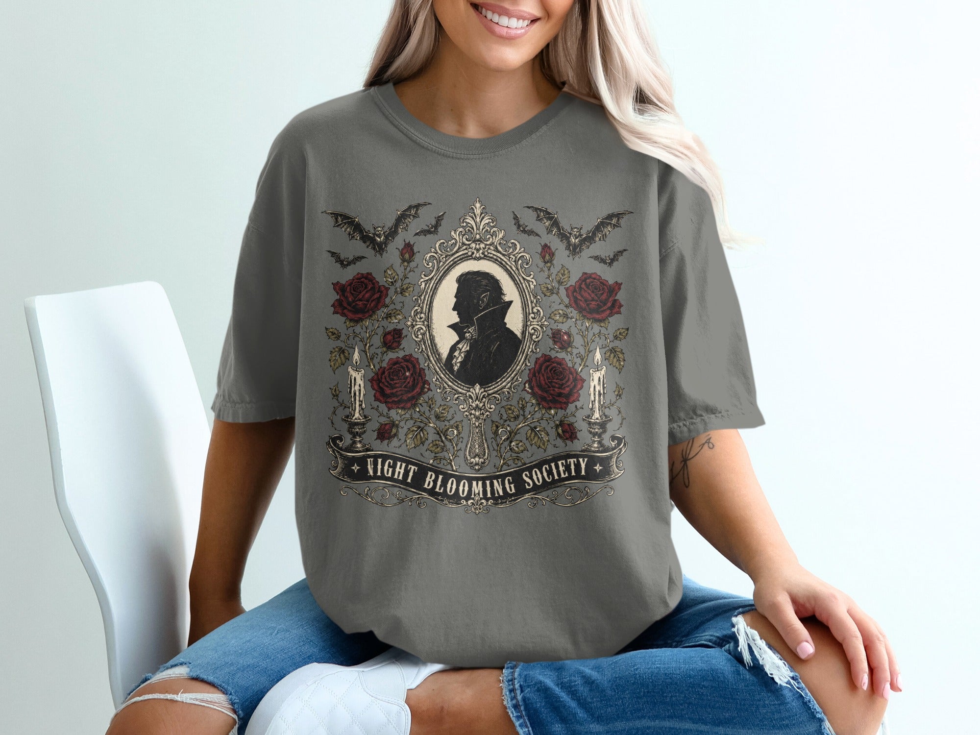 Dark grey t-shirt with gothic design of bats, roses, candles, and a silhouette of a vampire.