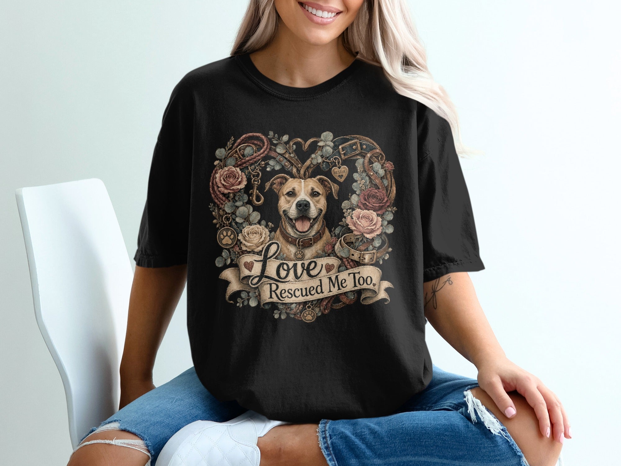 Dog wearing collar surrounded by roses, leather, and banner with "Love Rescued Me Too" text.