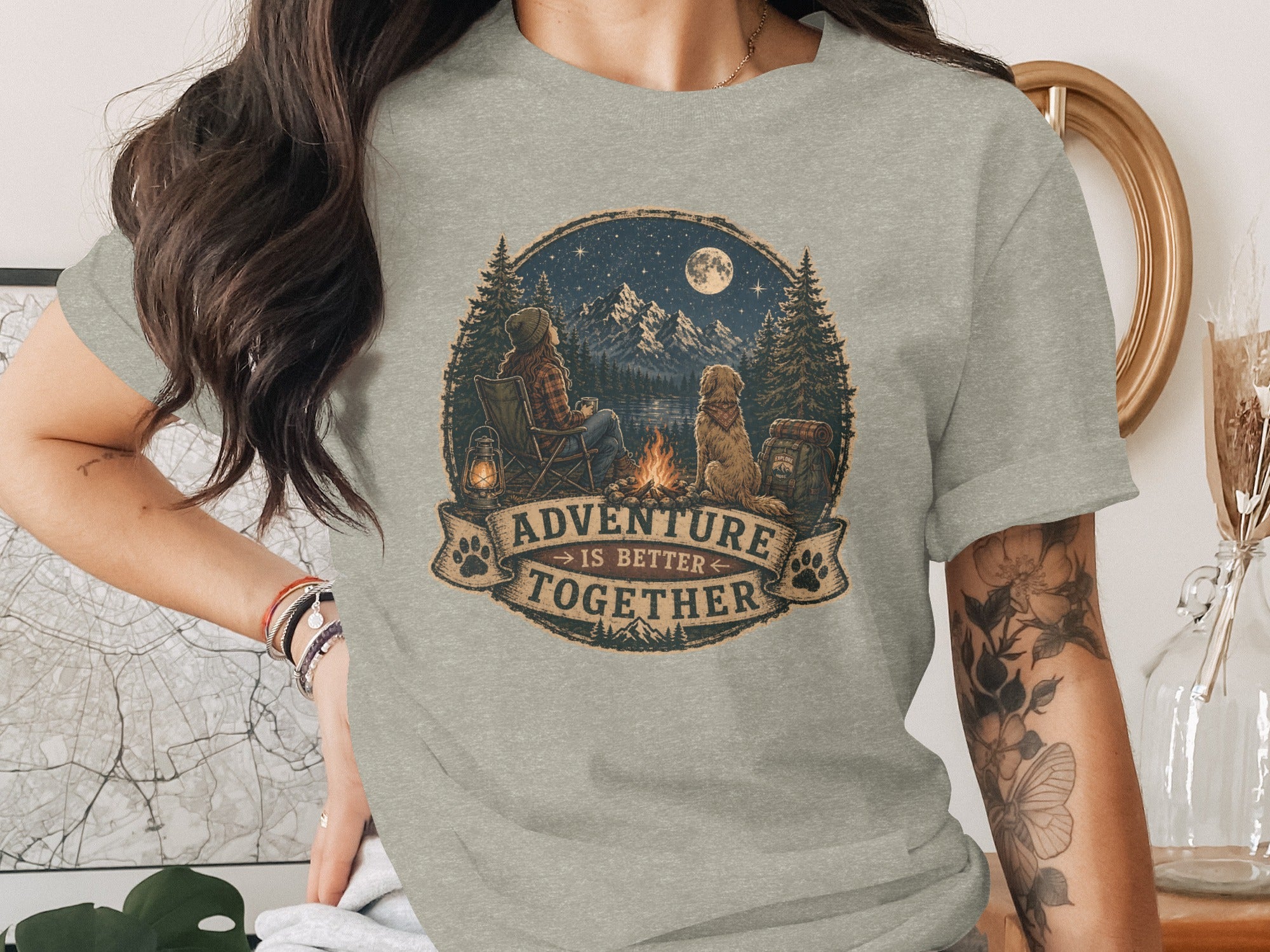 T-shirt with graphic of person and dog by campfire under moonlit sky.