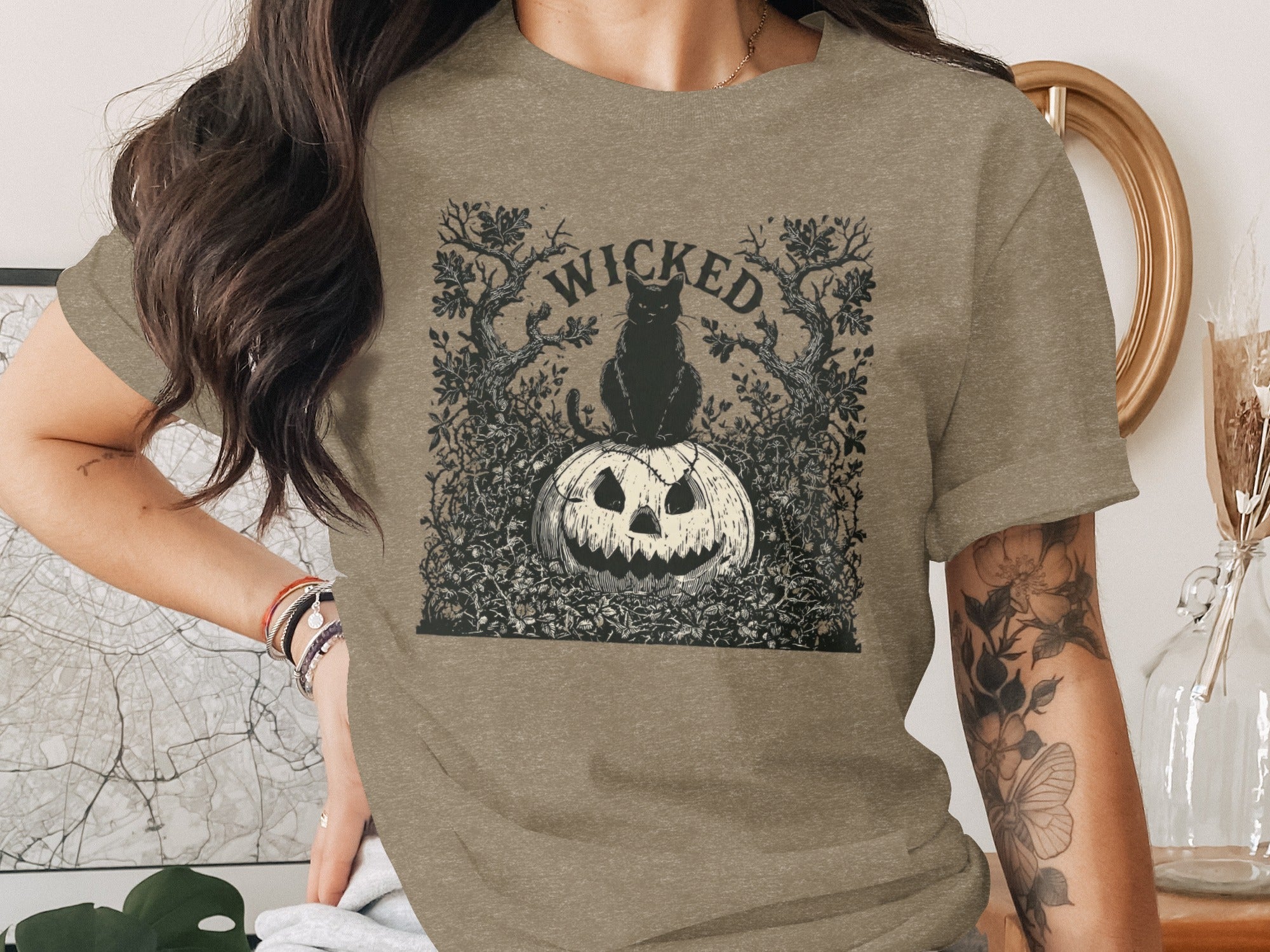 Graphic of a black cat on a jack-o'-lantern with "WICKED" text.