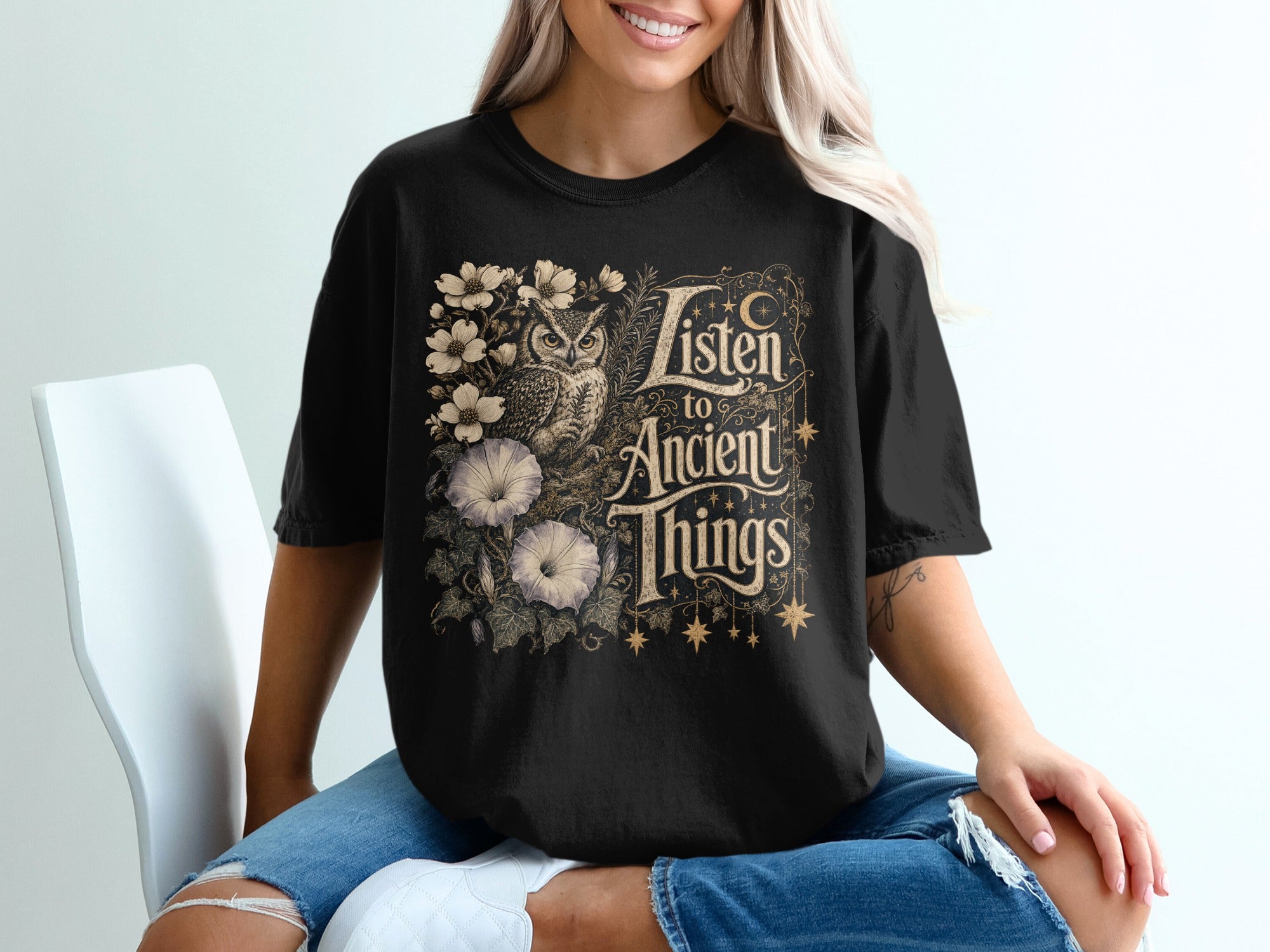 Black t-shirt with owl, flowers, and text "Listen to Ancient Things".