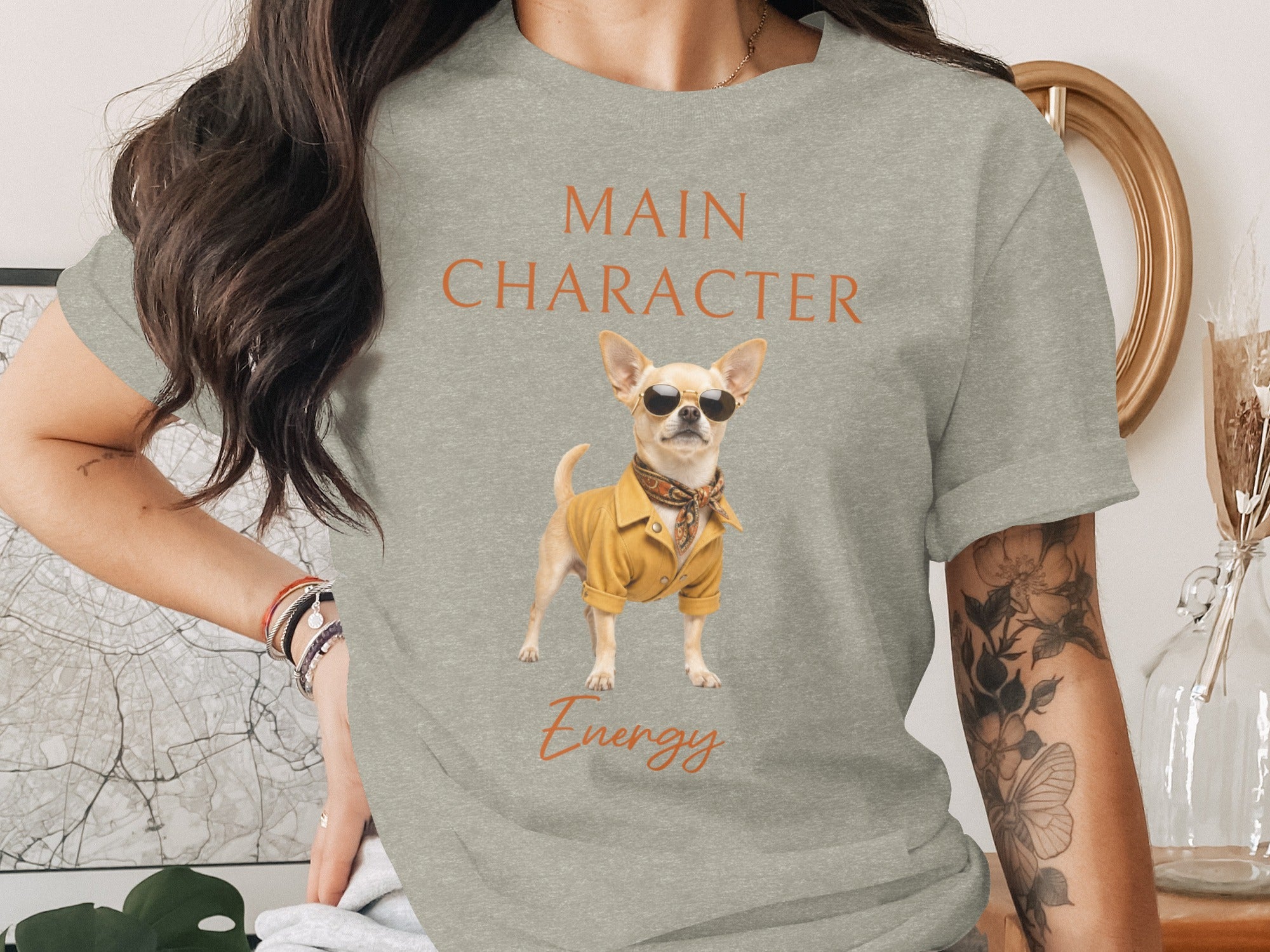 Light grey t-shirt with orange text "MAIN CHARACTER" and a chihuahua wearing sunglasses and a yellow jacket.