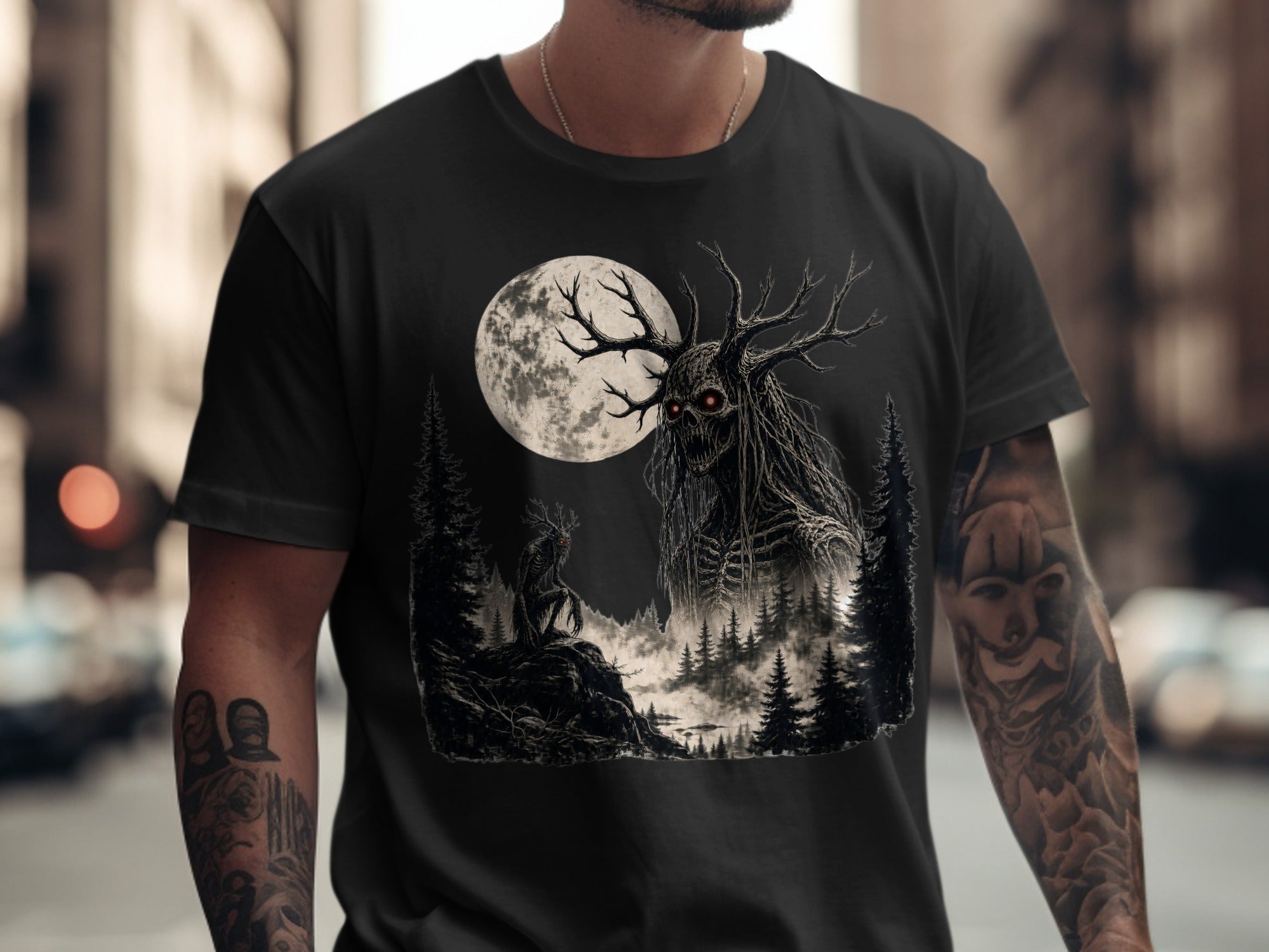 Black t-shirt with a dark forest scene featuring a creature and a large moon.