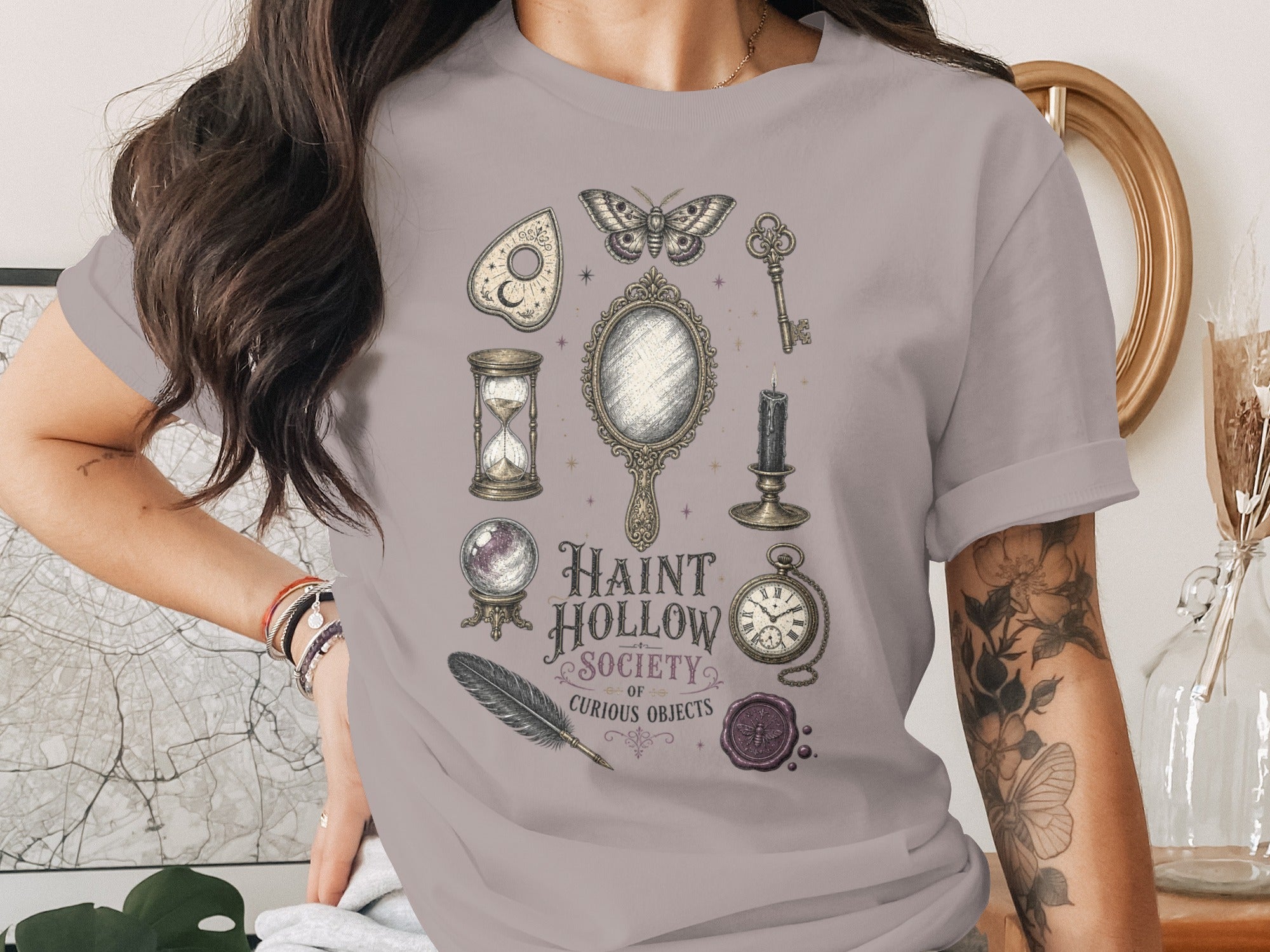 T-shirt with Haunt Hollow Society of Curious Objects print featuring mystical items.