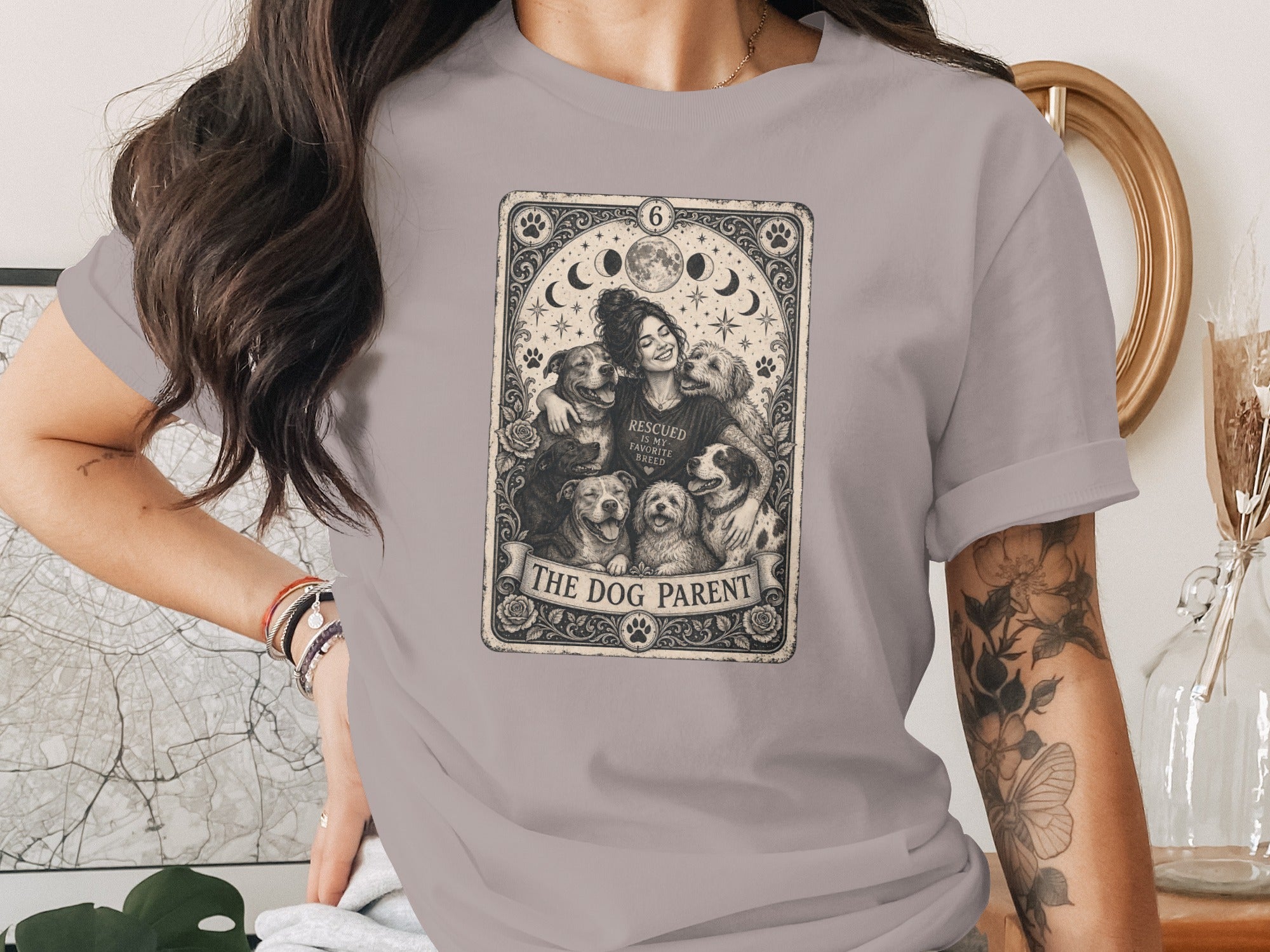 T-shirt with Tarot card design of woman embracing dogs, "THE DOG PARENT".