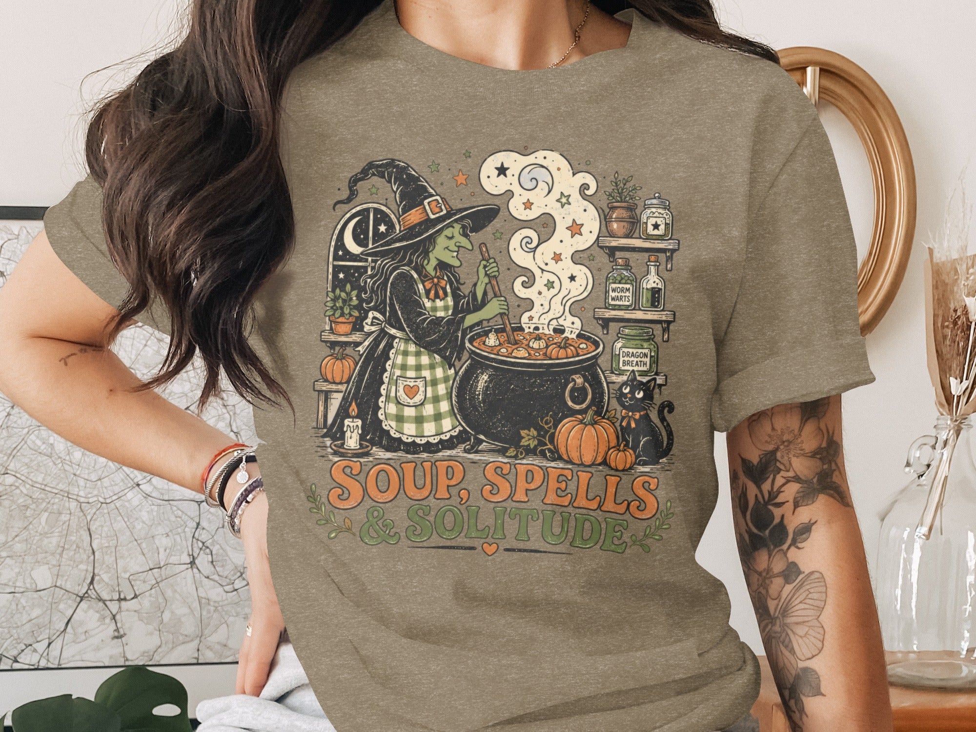 Witch stirring cauldron with black cat and text "Soup, Spells & Solitude".