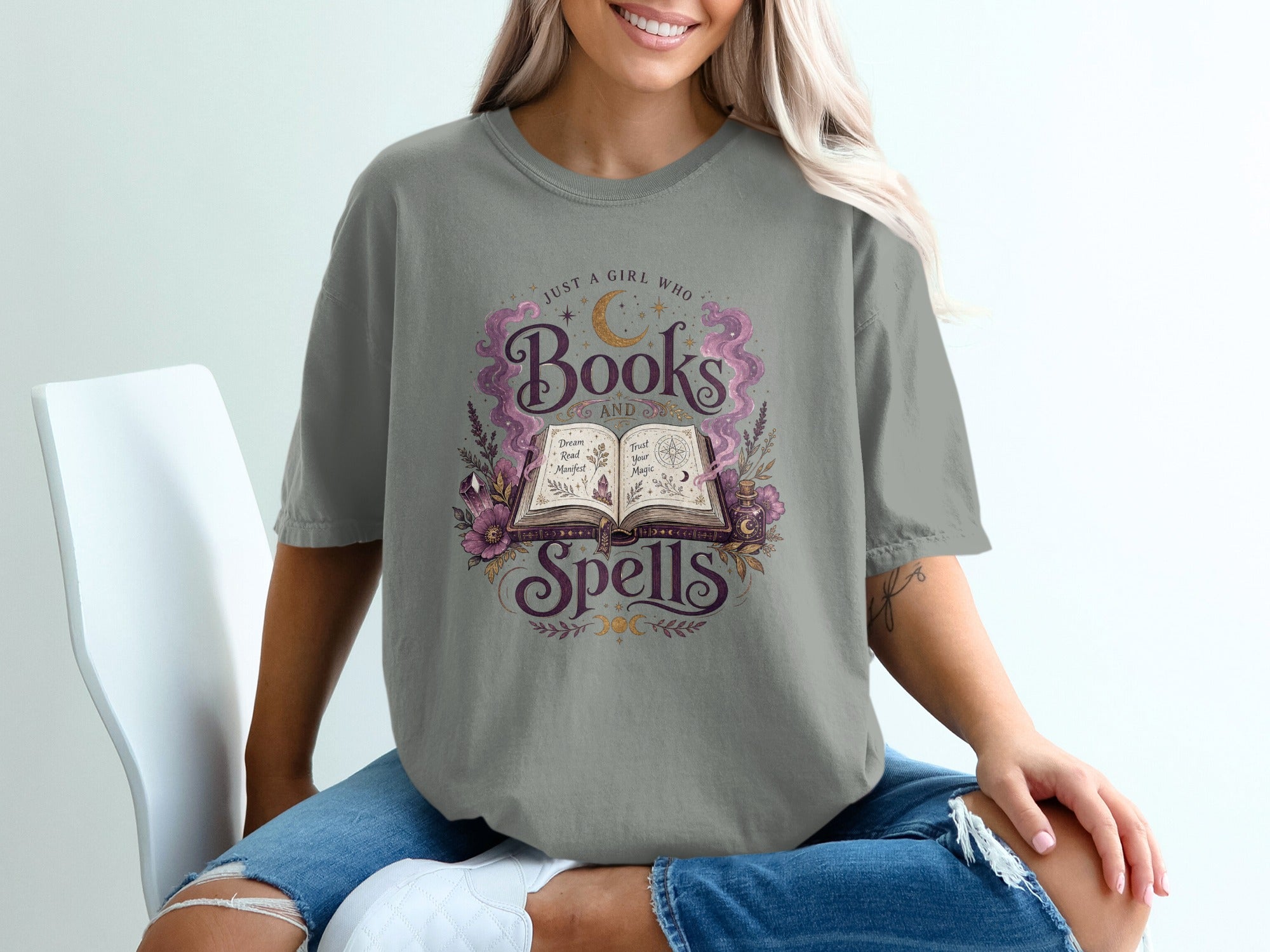 Gray t-shirt with "Books and Spells" text and magical illustrations.