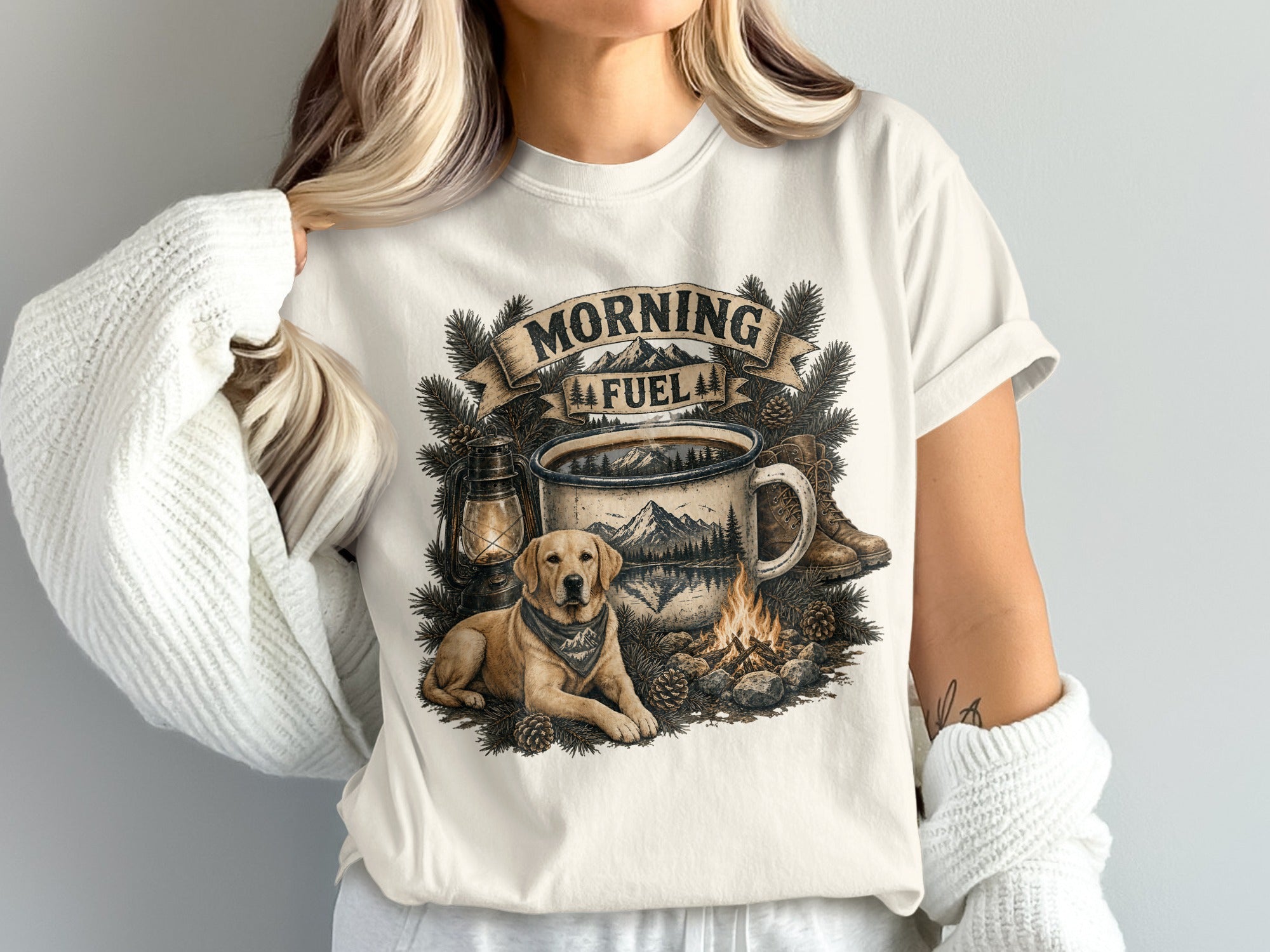 T-shirt graphic: "Morning Fuel" text, camping scene with dog, coffee mug, lantern, campfire, and boots.