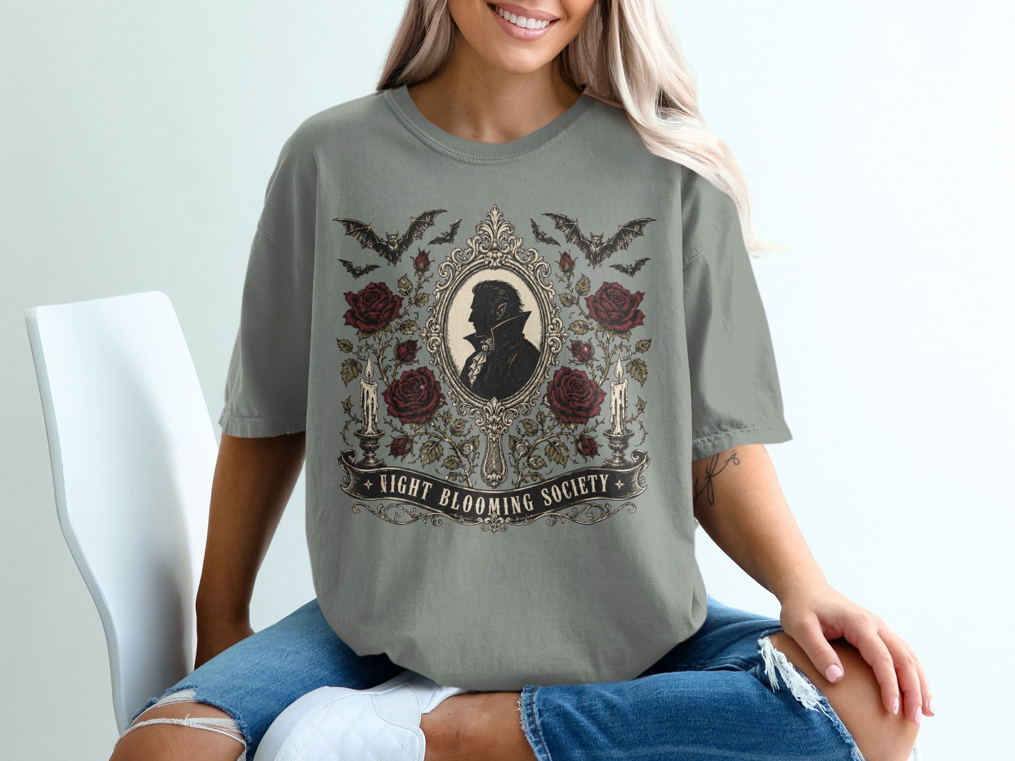 Grey t-shirt with gothic design featuring bats, roses, candles, and "Night Blooming Society" text.
