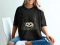 Black t-shirt with a vintage Halloween graphic of a cat on a pumpkin.