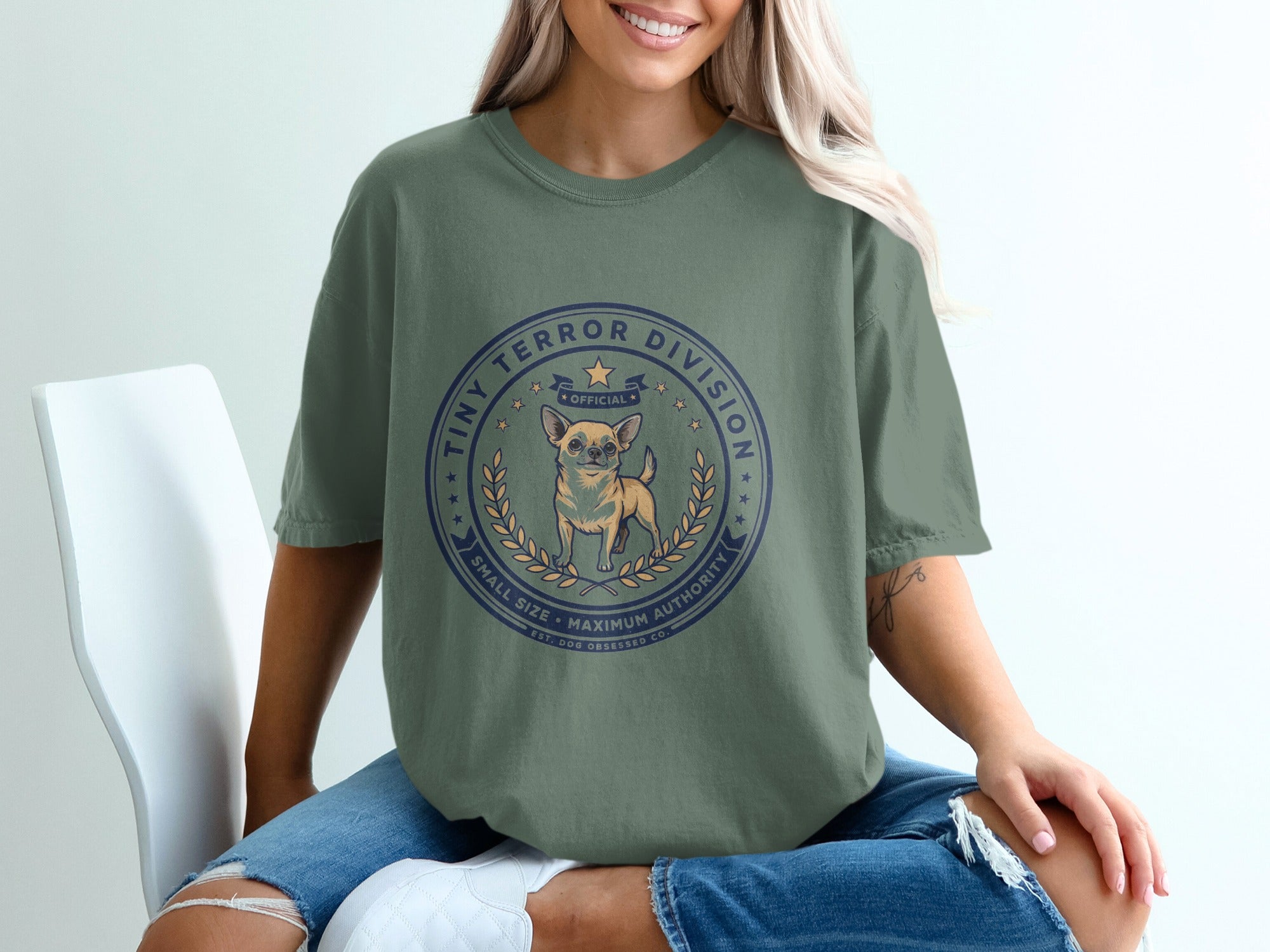 Green t-shirt with "Tiny Terror Division" graphic featuring a chihuahua and laurel wreath.