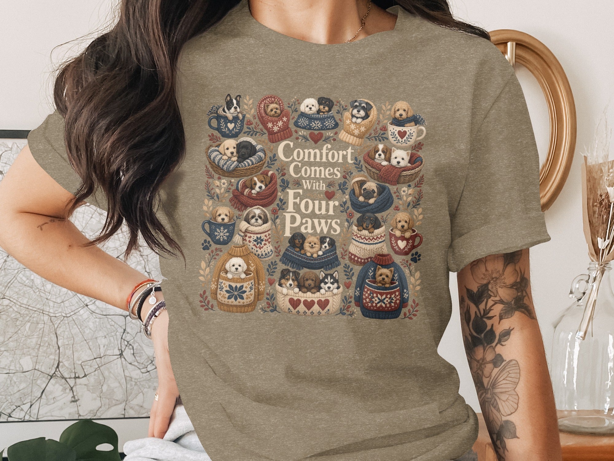 T-shirt graphic with various puppies in knitted sweaters, cups, and baskets with text "Comfort Comes With Four Paws."