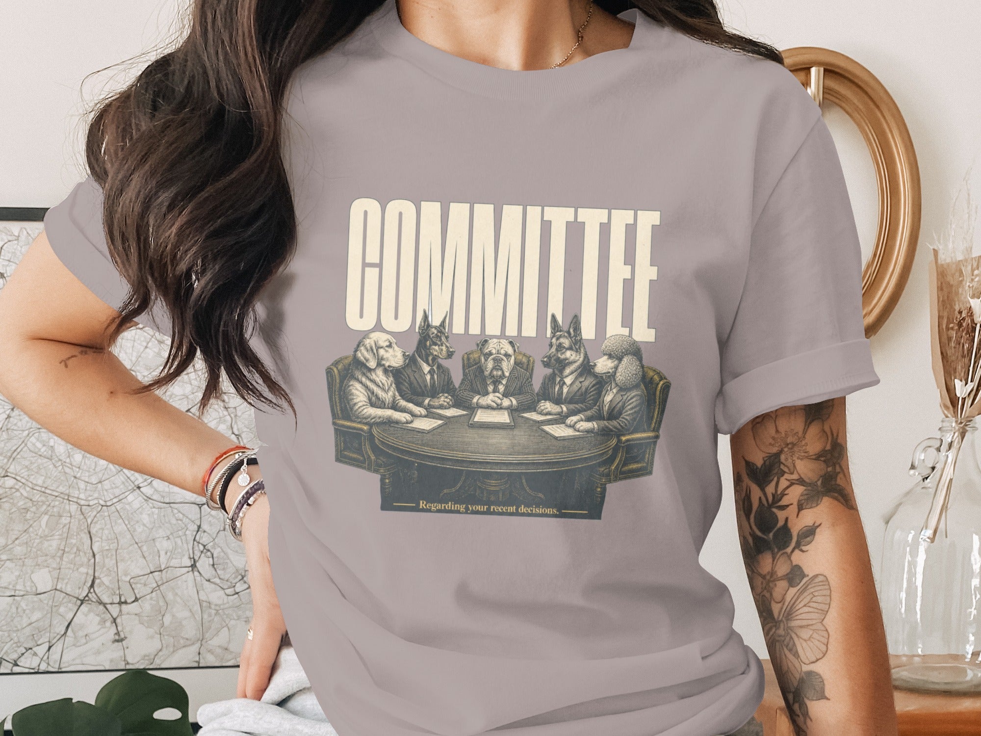 Dogs in suits sit around a table with the text "COMMITTEE" and "Regarding your recent decisions."