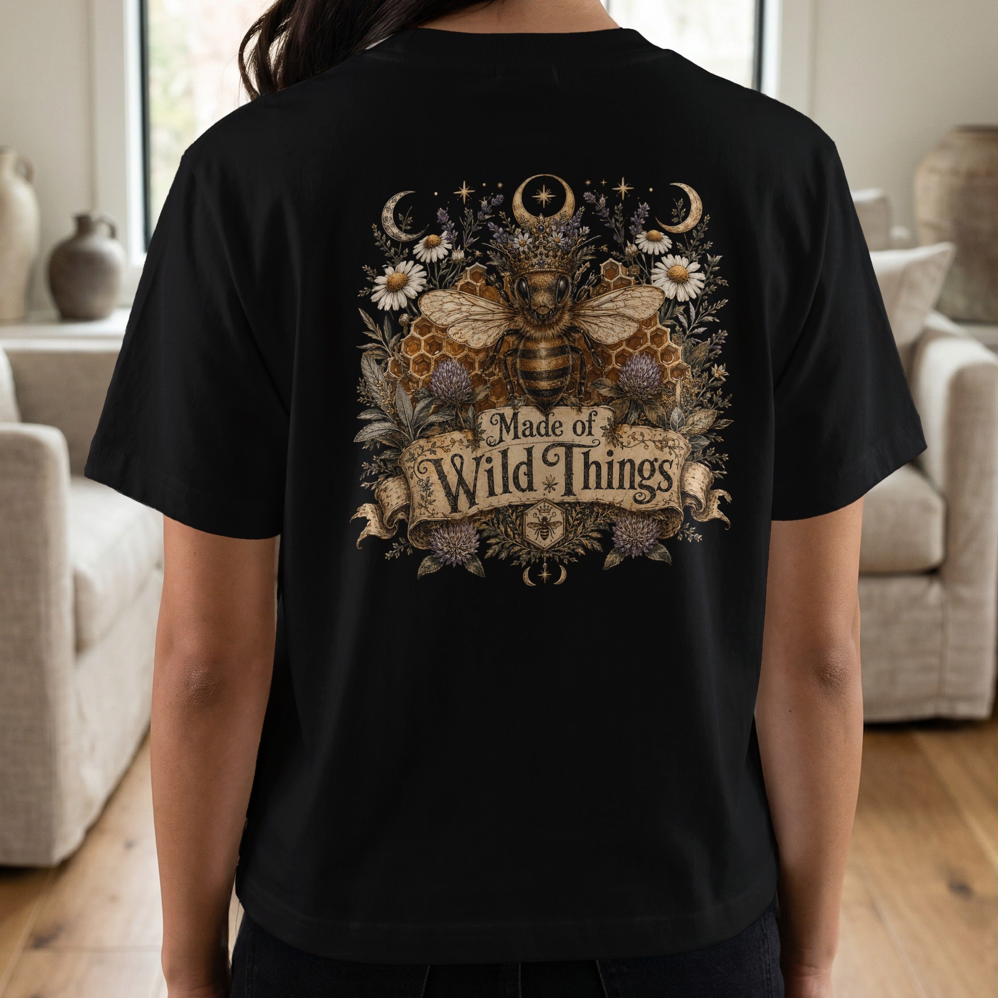 Black t-shirt featuring a detailed bee with a crown and text "Made of Wild Things".