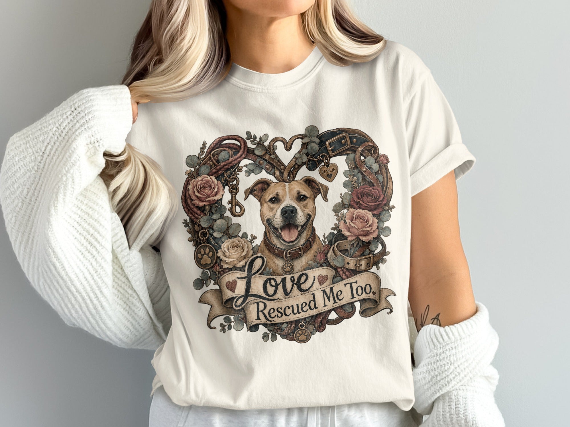 Dog embraces heart-shaped wreath of roses, leashes, collars, and text "Love Rescued Me Too".