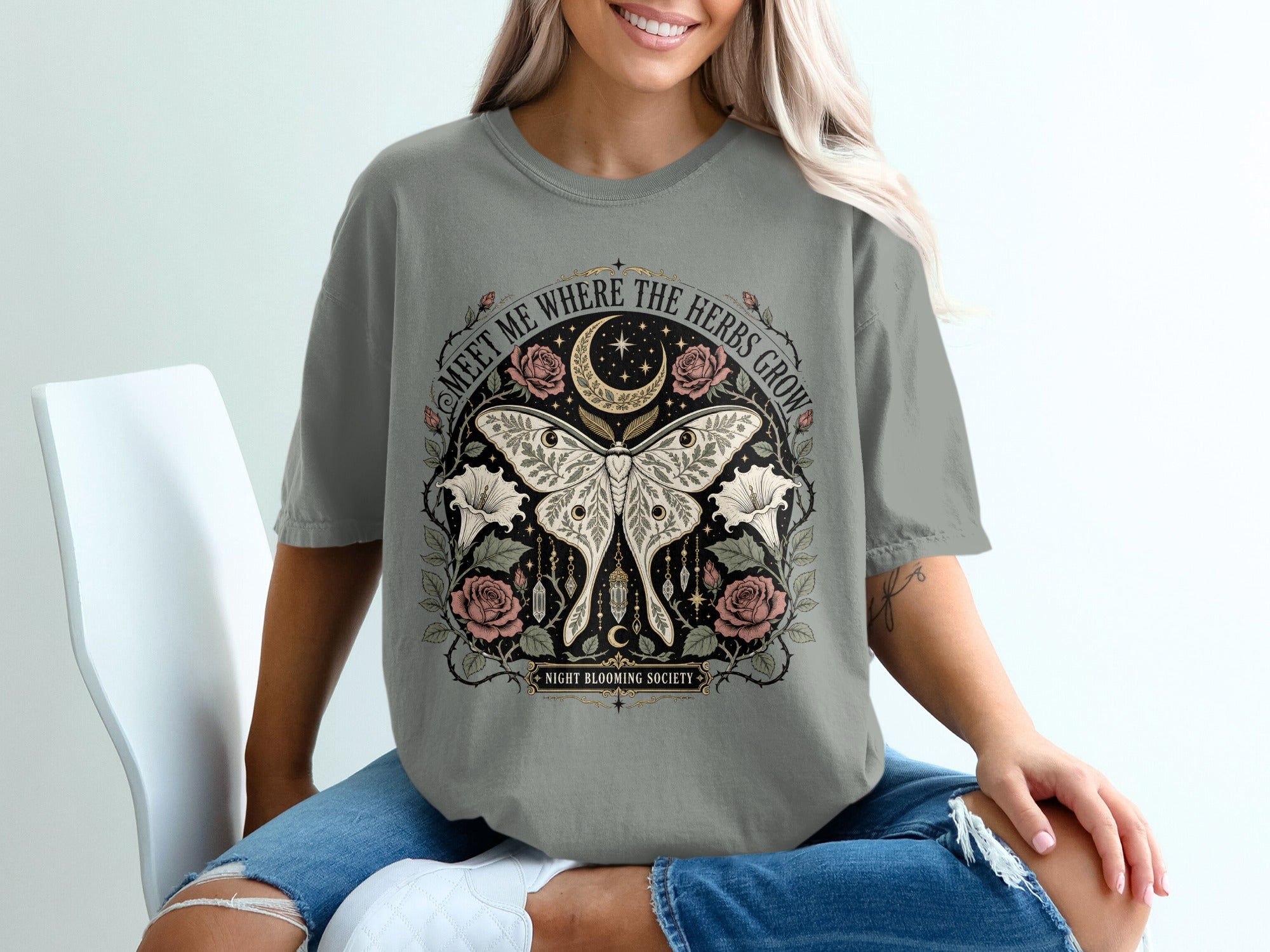 T-shirt with moth, moon, roses, night blooming society, and text "Meet Me Where The Herbs Grow".