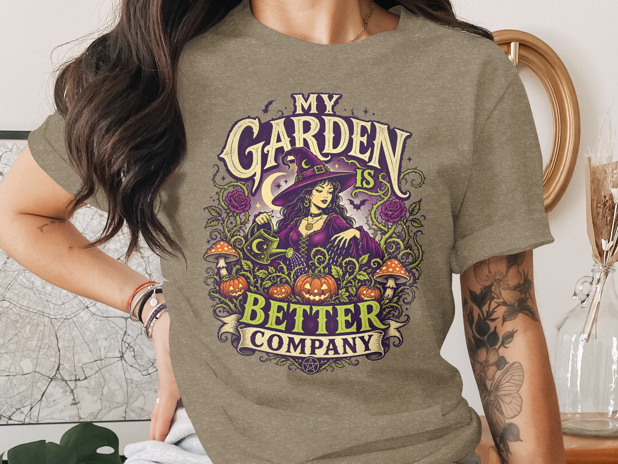 T-shirt with graphic: "My Garden is Better Company" featuring a witch, pumpkins, mushrooms, roses.