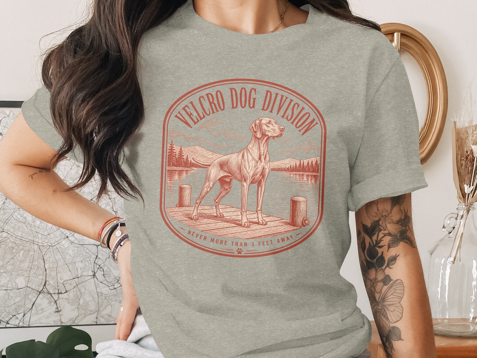 T-shirt with a circular graphic featuring a dog on a dock and text "Velcro Dog Division".