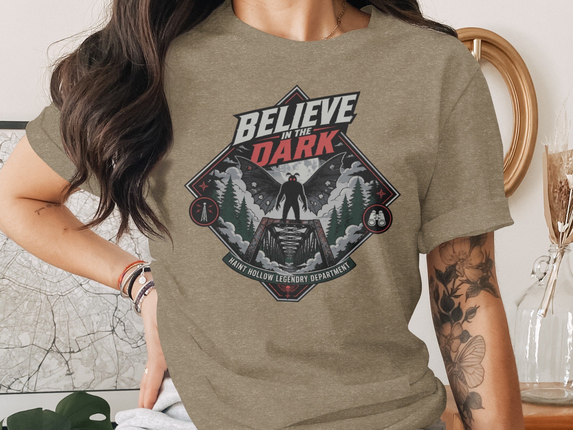 Believe in the Dark graphic tee: mothman on bridge, forest, moon, Haunt Hollow Legendry Department.