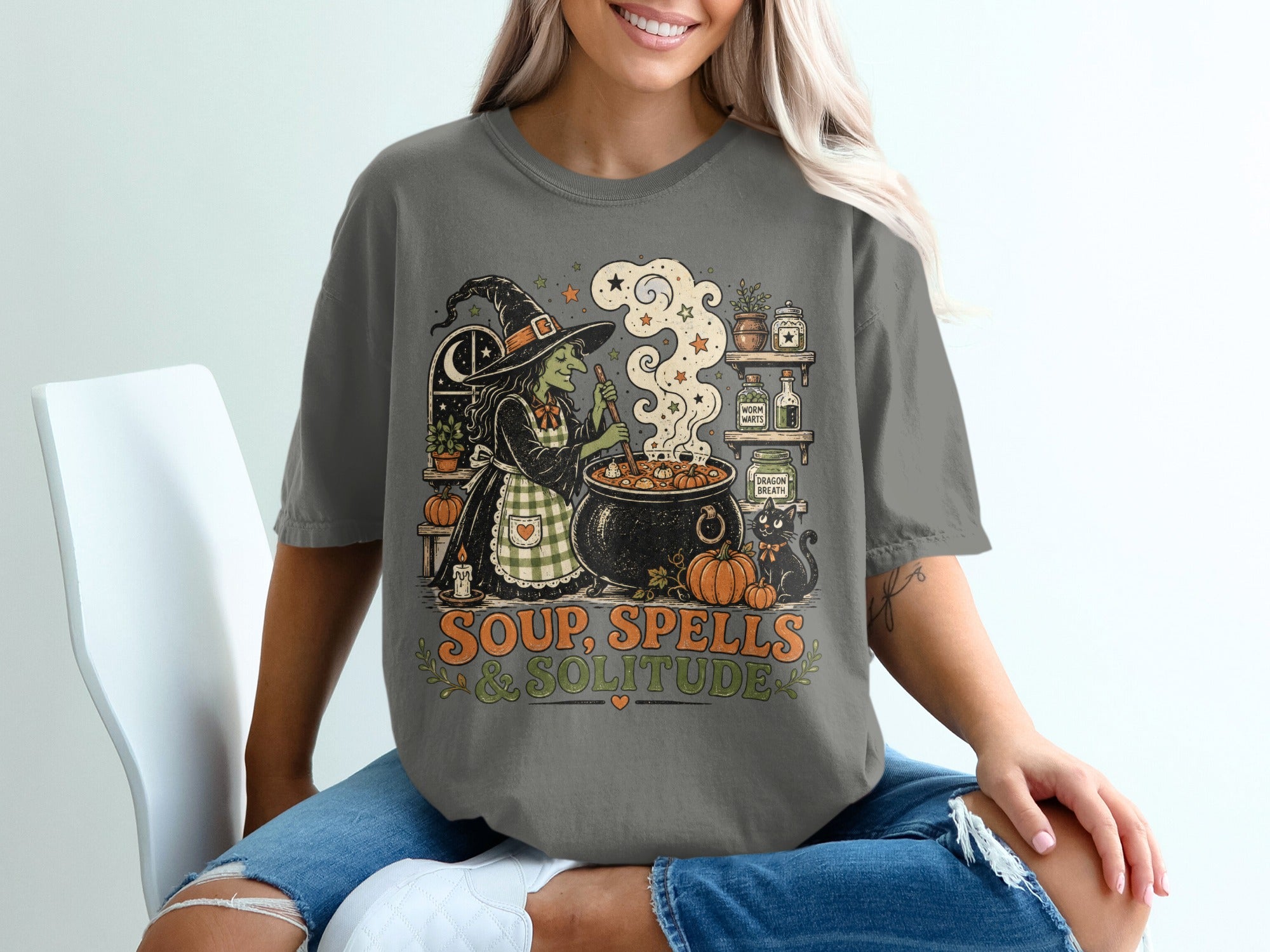 Witch making soup with cauldron, black cat, pumpkins, and text "Soup, Spells & Solitude".
