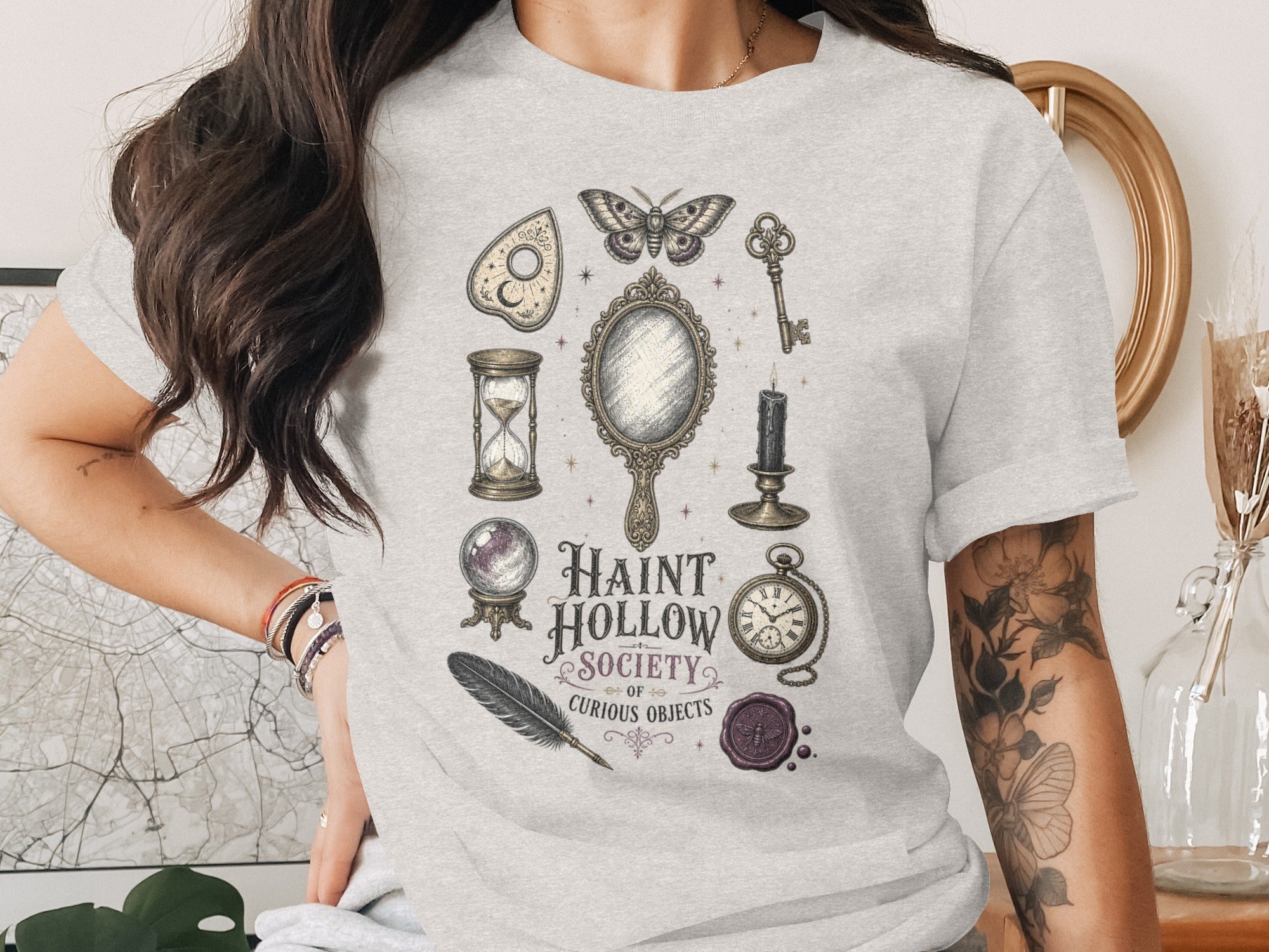 Light gray t-shirt with "HAINT HOLLOW SOCIETY OF CURIOUS OBJECTS" and occult imagery.