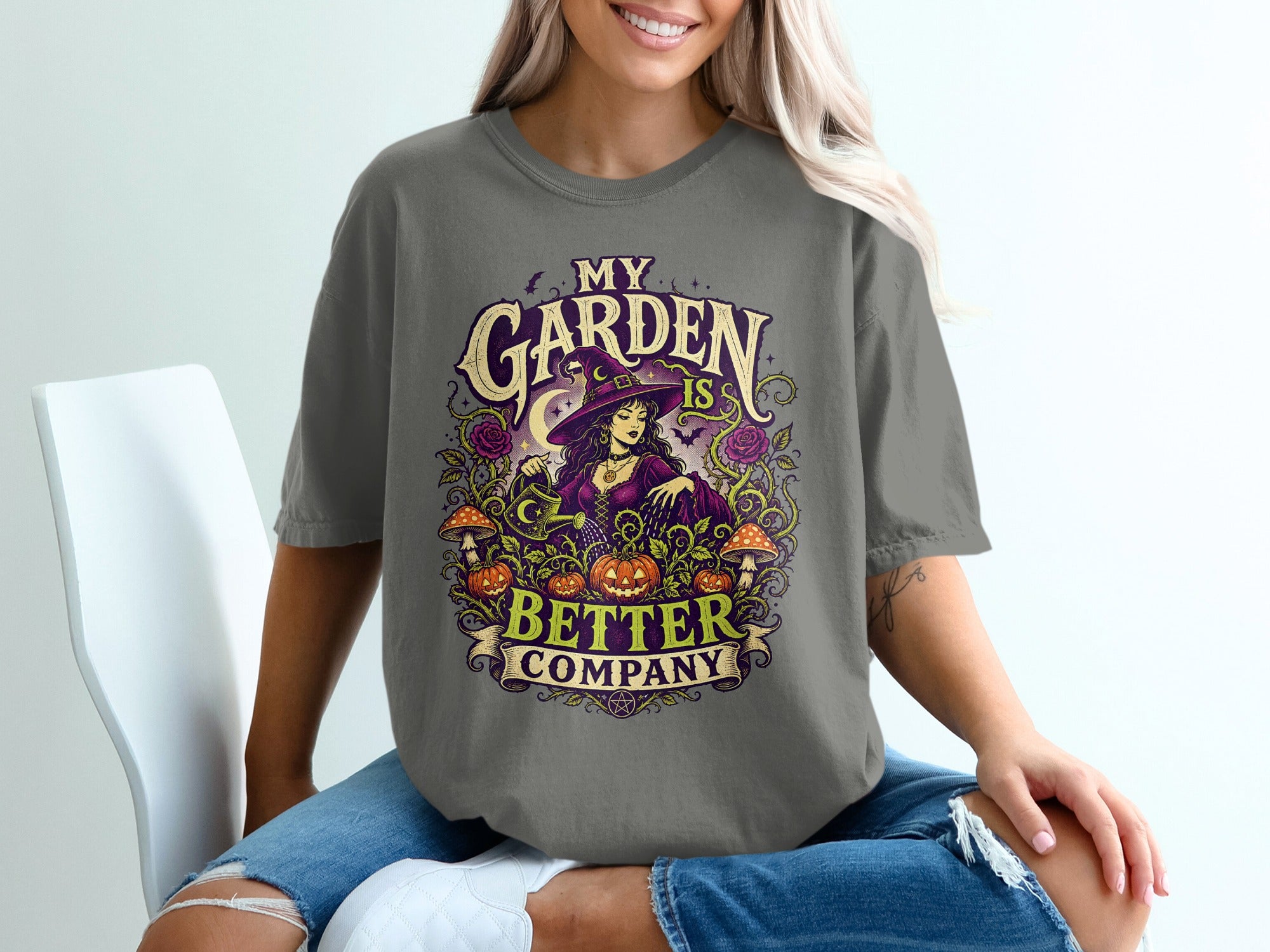 T-shirt graphic: Witch tending pumpkins and mushrooms, "My Garden is Better Company".