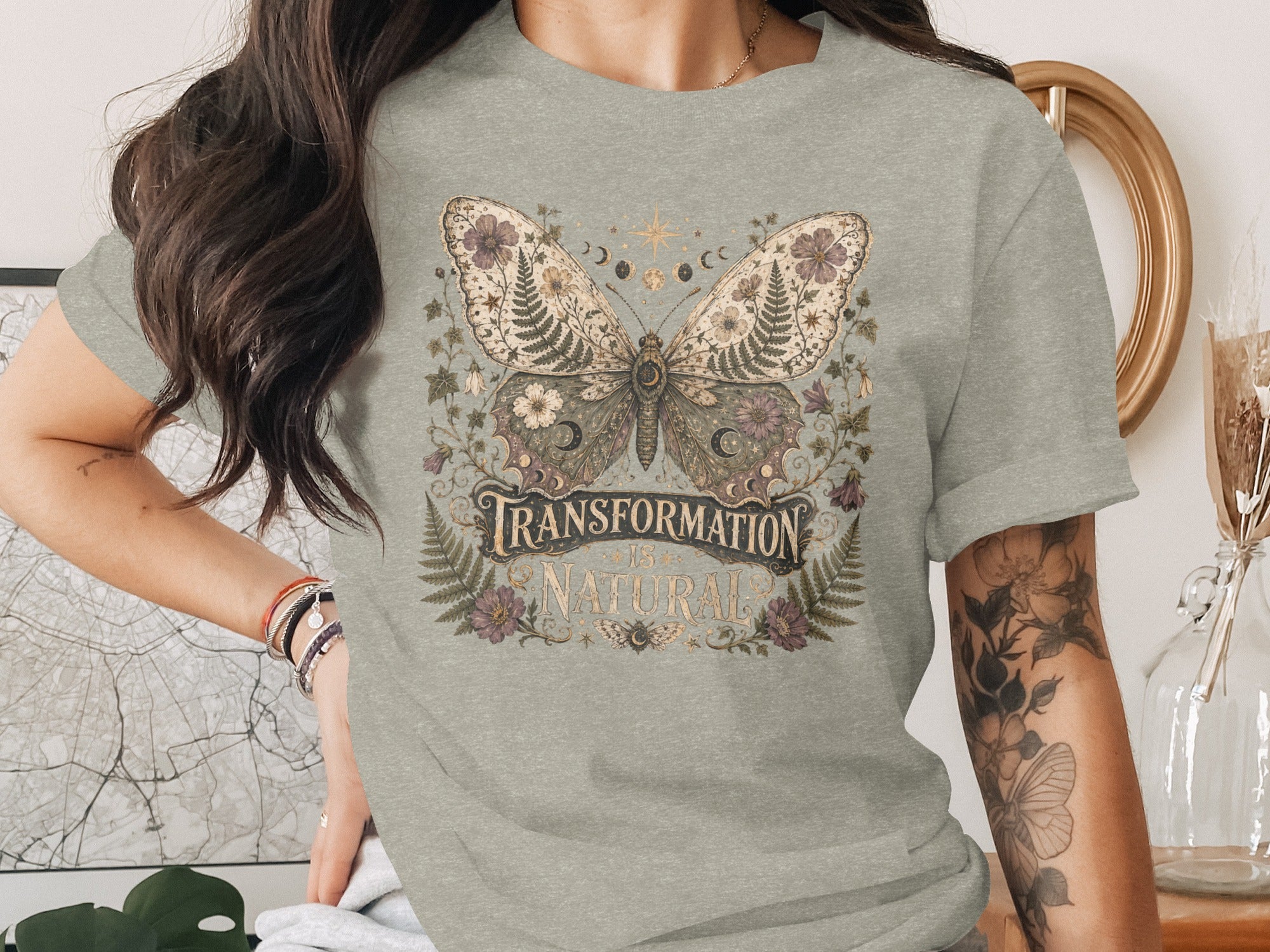 T-shirt with butterfly and moon phases design, reads: Transformation is Natural