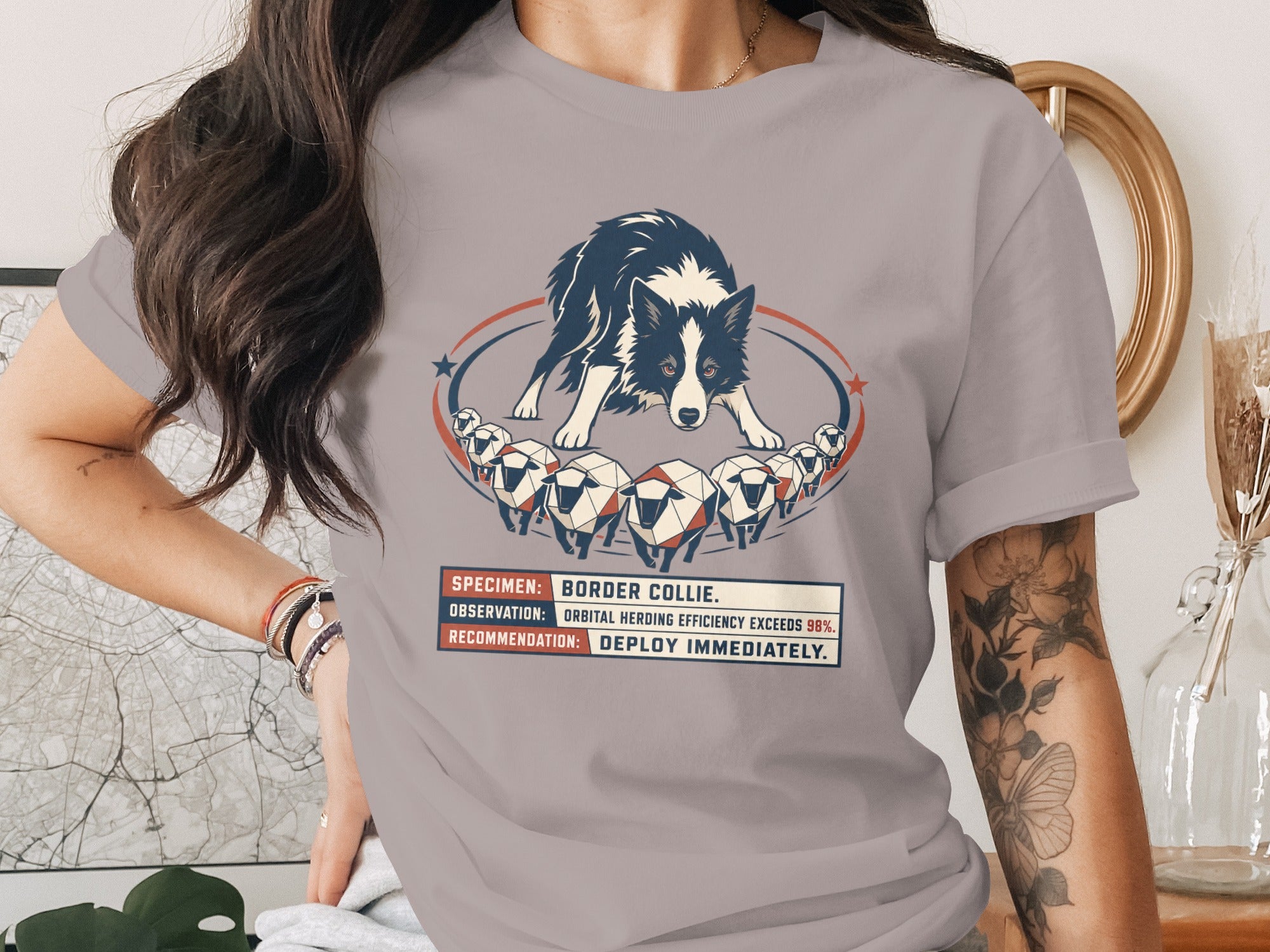 T-shirt graphic featuring a Border Collie surrounded by sheep. Text reads: "Specimen: Border Collie. Observation: Orbital herding efficiency exceeds 98%. Recommendation: Deploy immediately."