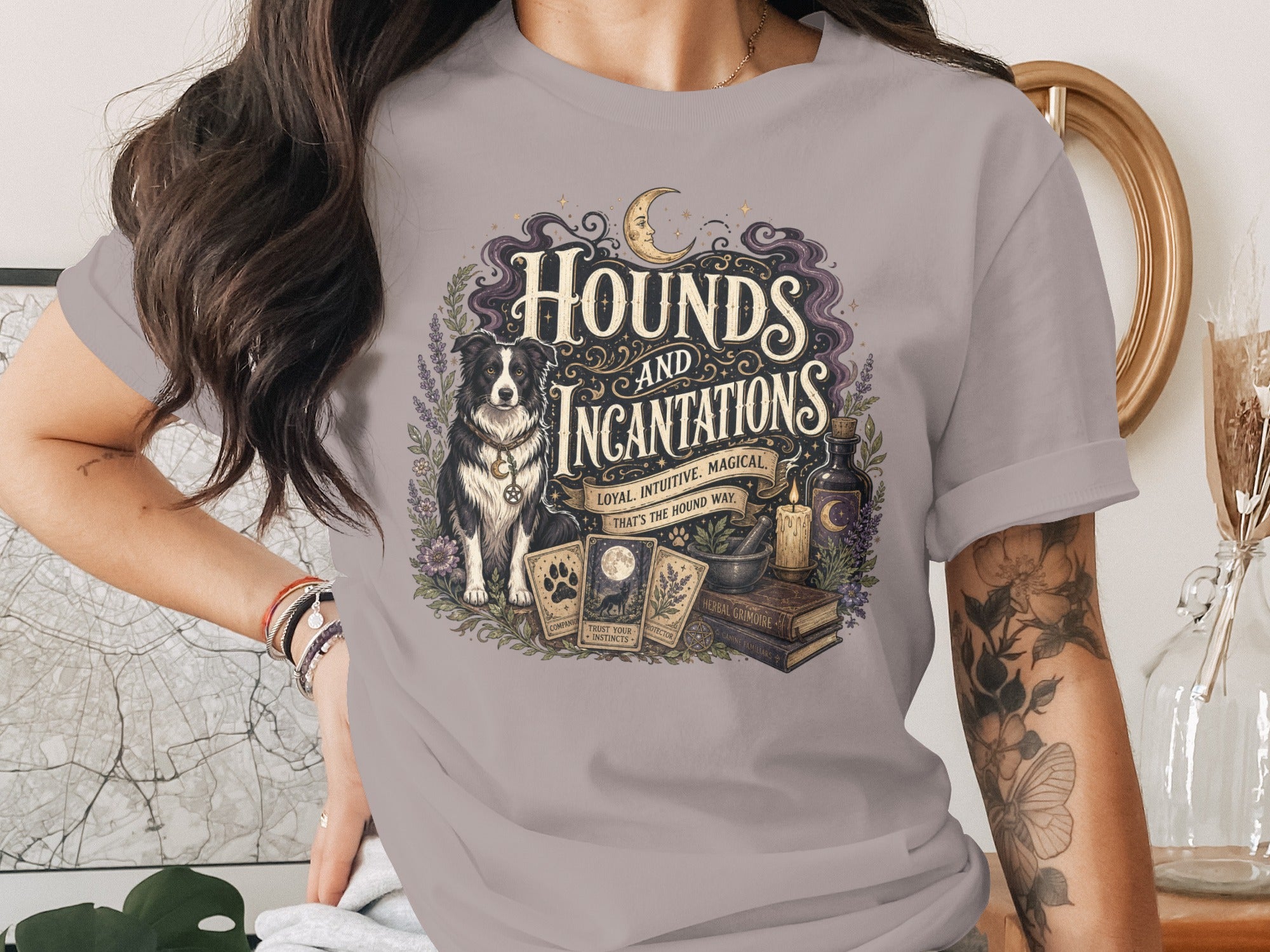 T-shirt graphic with border collie, tarot cards, and "Hounds and Incantations" text.