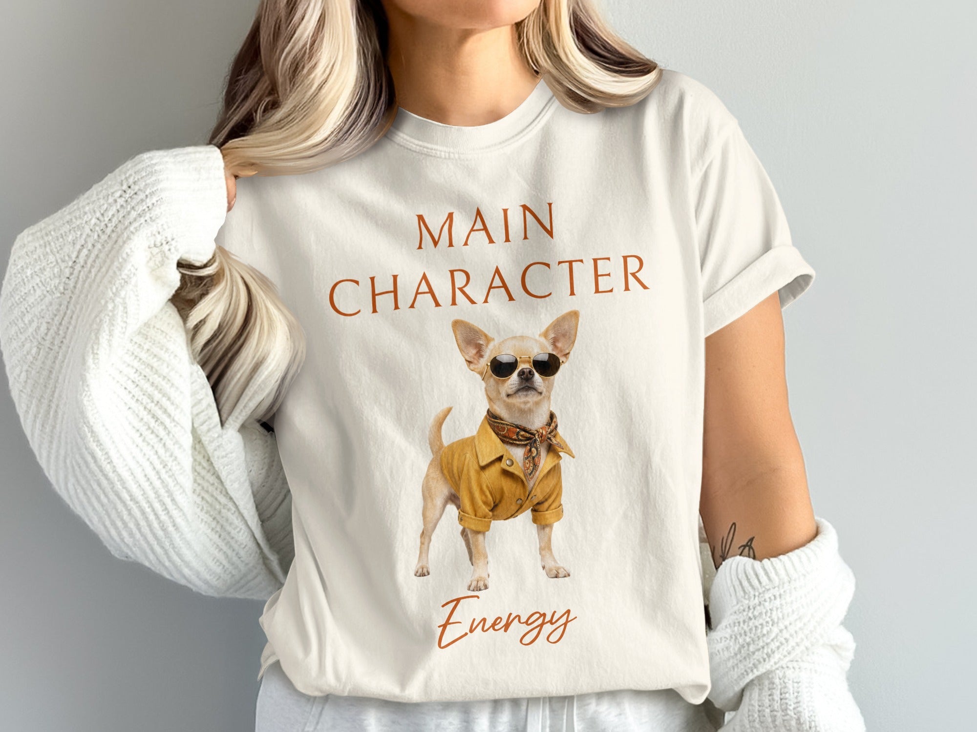 White t-shirt with "MAIN CHARACTER Energy" text and a chihuahua in sunglasses.