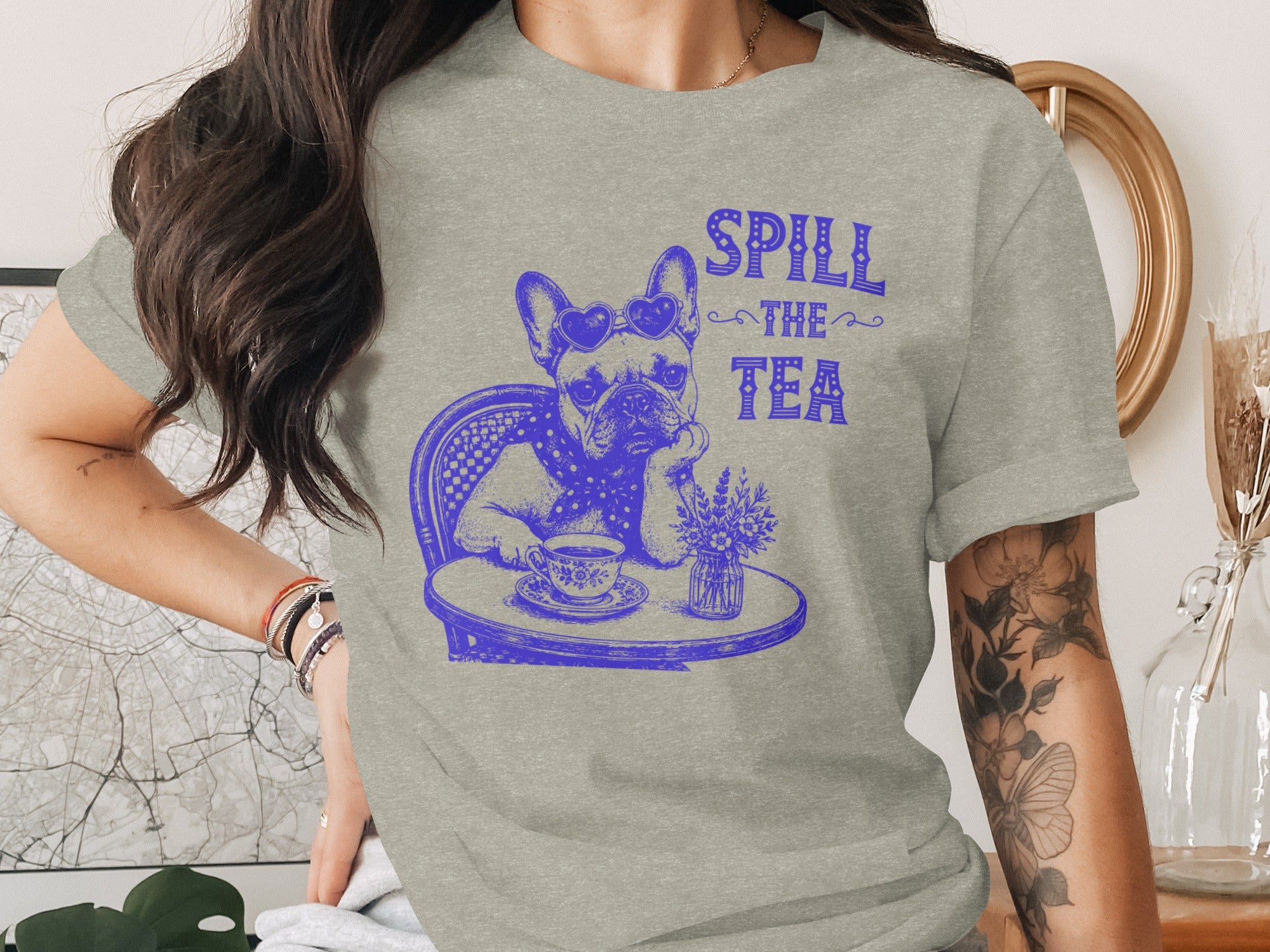 French Bulldog with heart sunglasses "Spill the Tea" text, sitting at a table with tea.