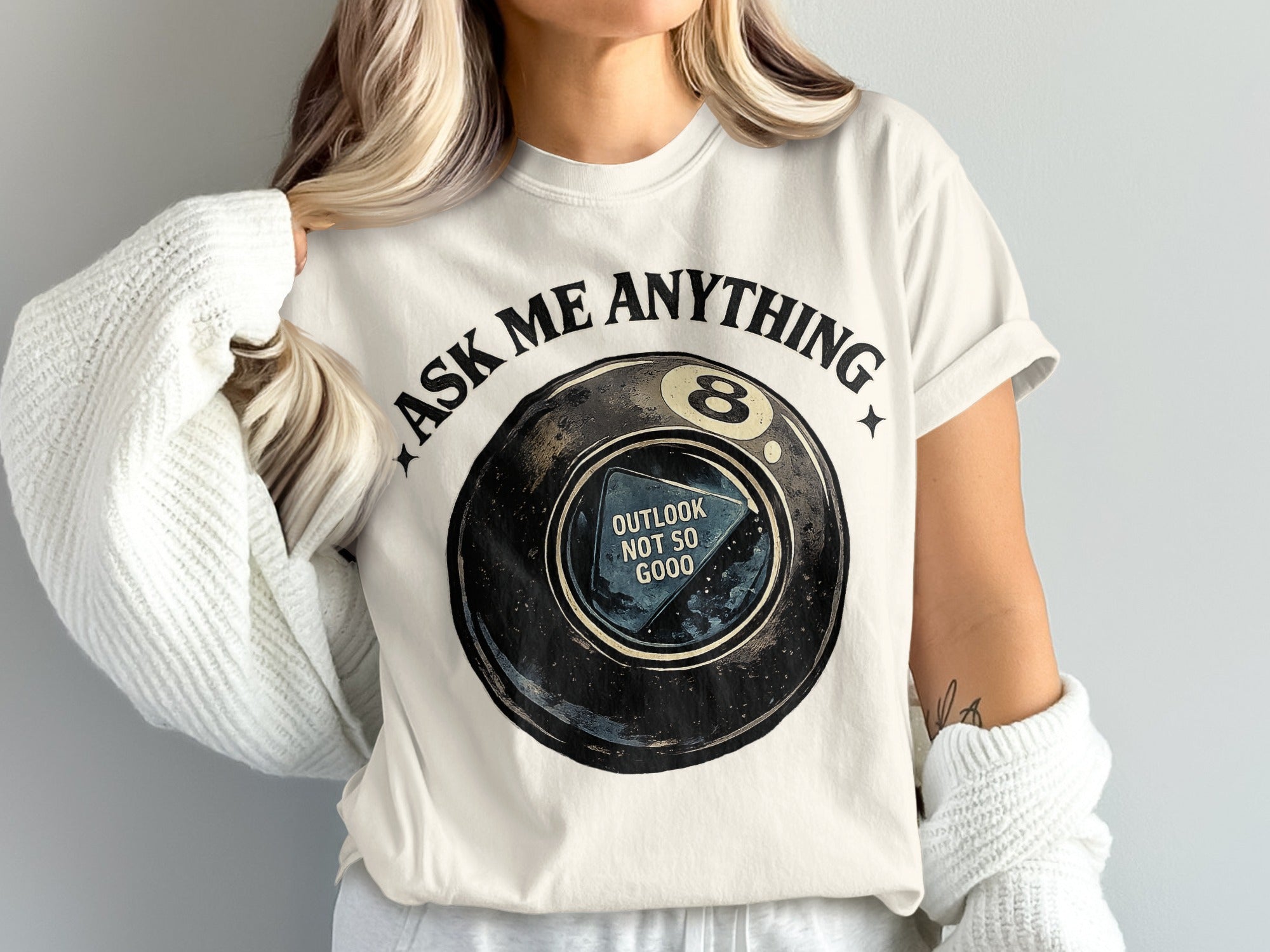T-shirt graphic of an 8-ball with "ASK ME ANYTHING" and "OUTLOOK NOT SO GOOD".