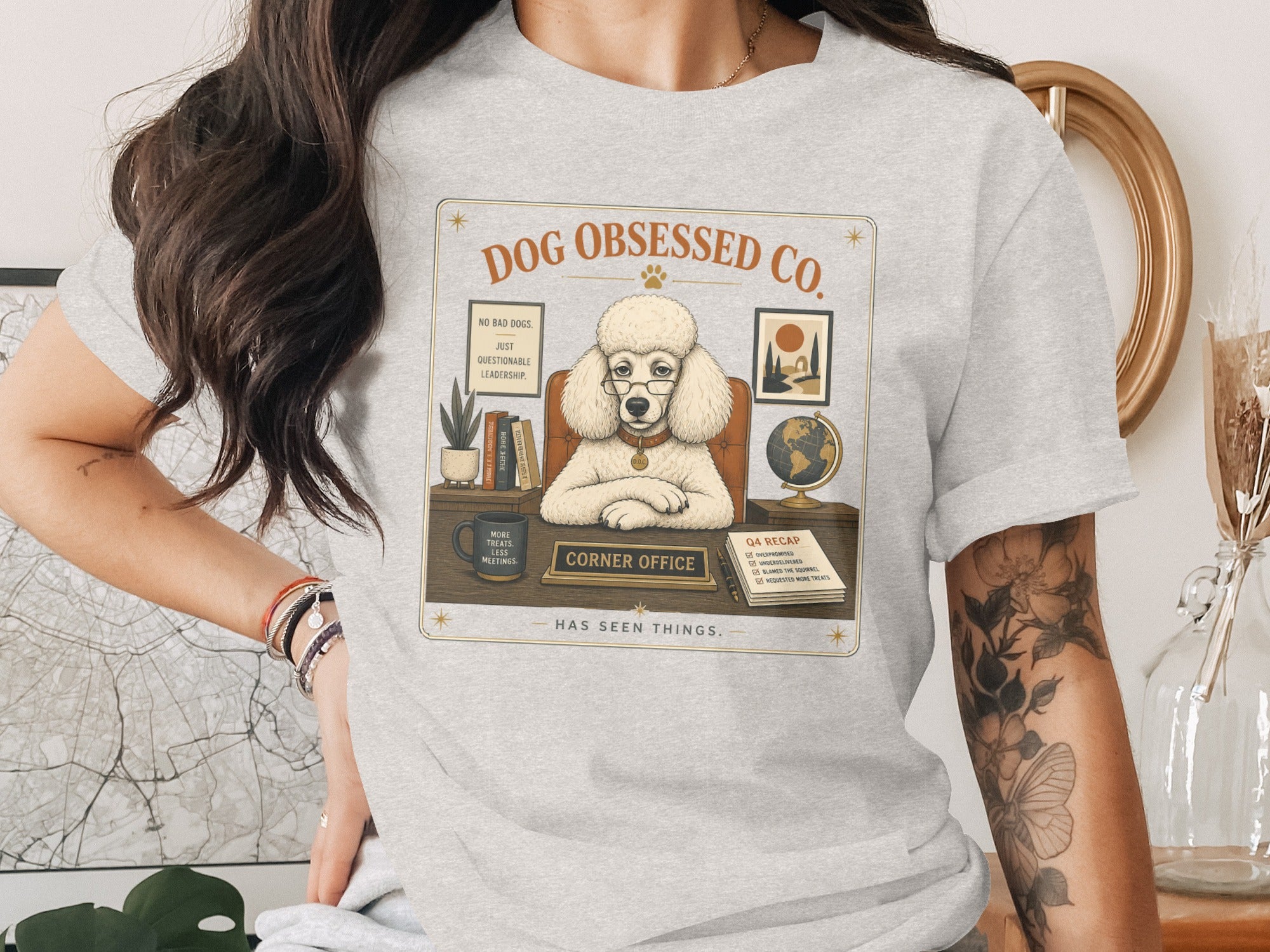 Poodle wearing glasses in "Corner Office" with "Dog Obsessed Co." text.