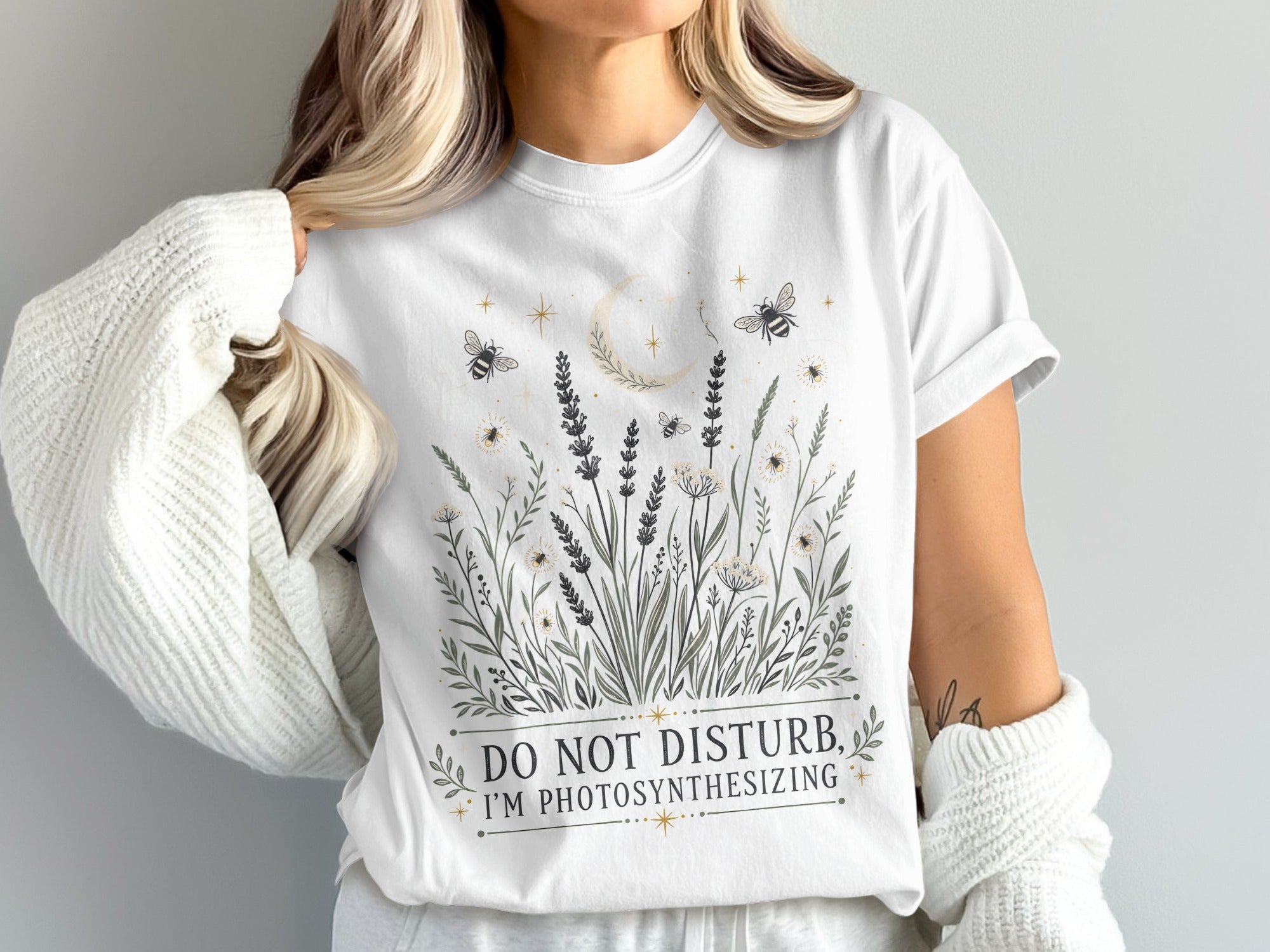 White t-shirt with "Do Not Disturb, I'm Photosynthesizing" and botanical design.