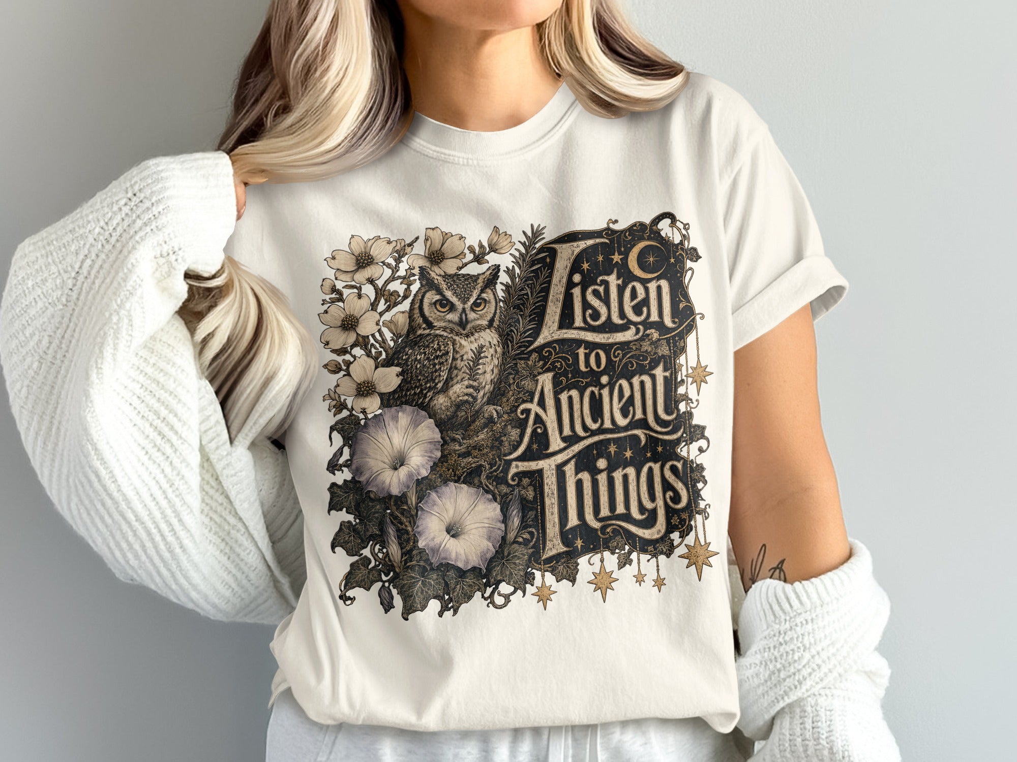 T-shirt with owl, flowers, and text "Listen to Ancient Things".