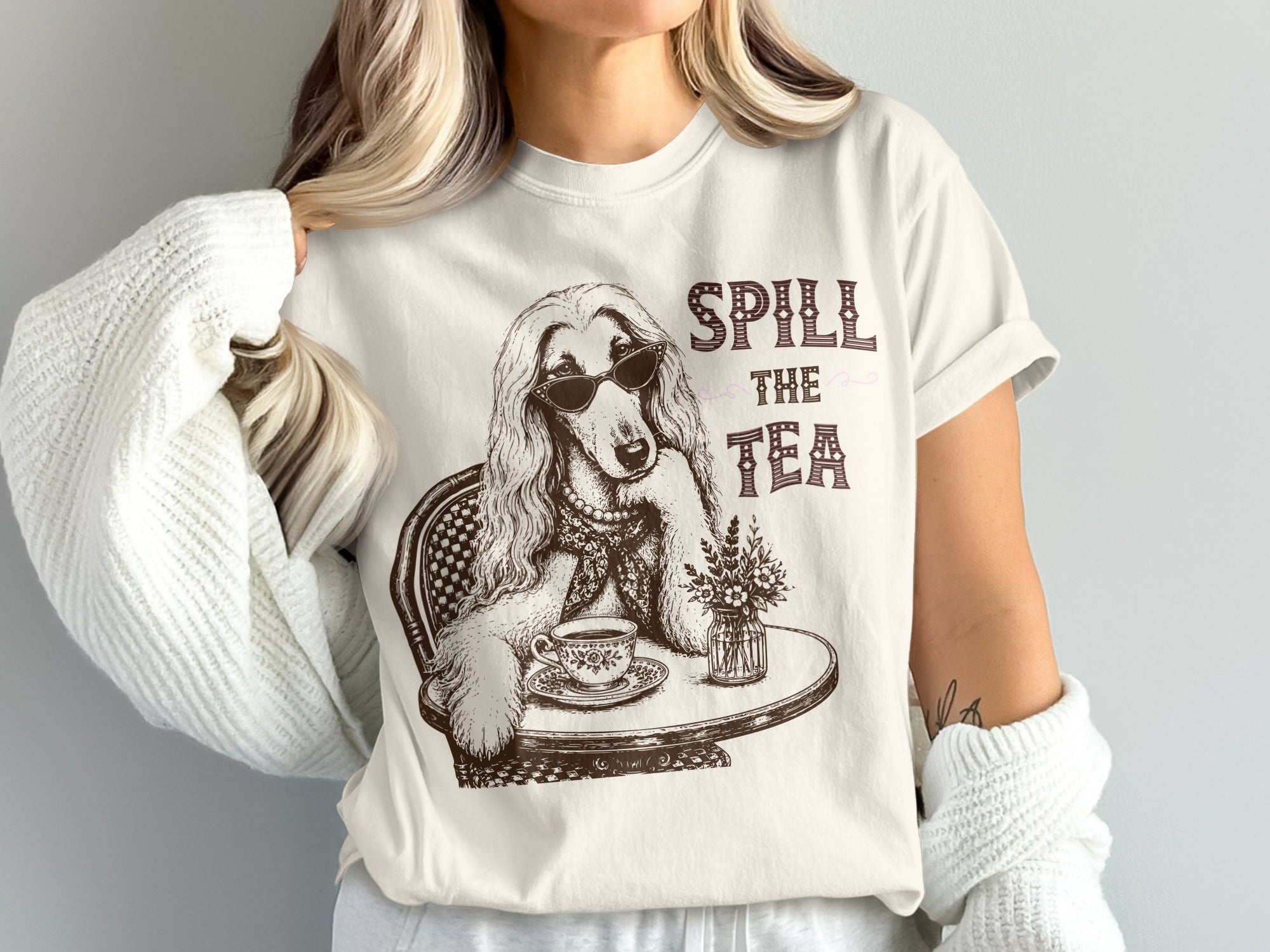T-shirt graphic of a dog wearing sunglasses at a table with tea.