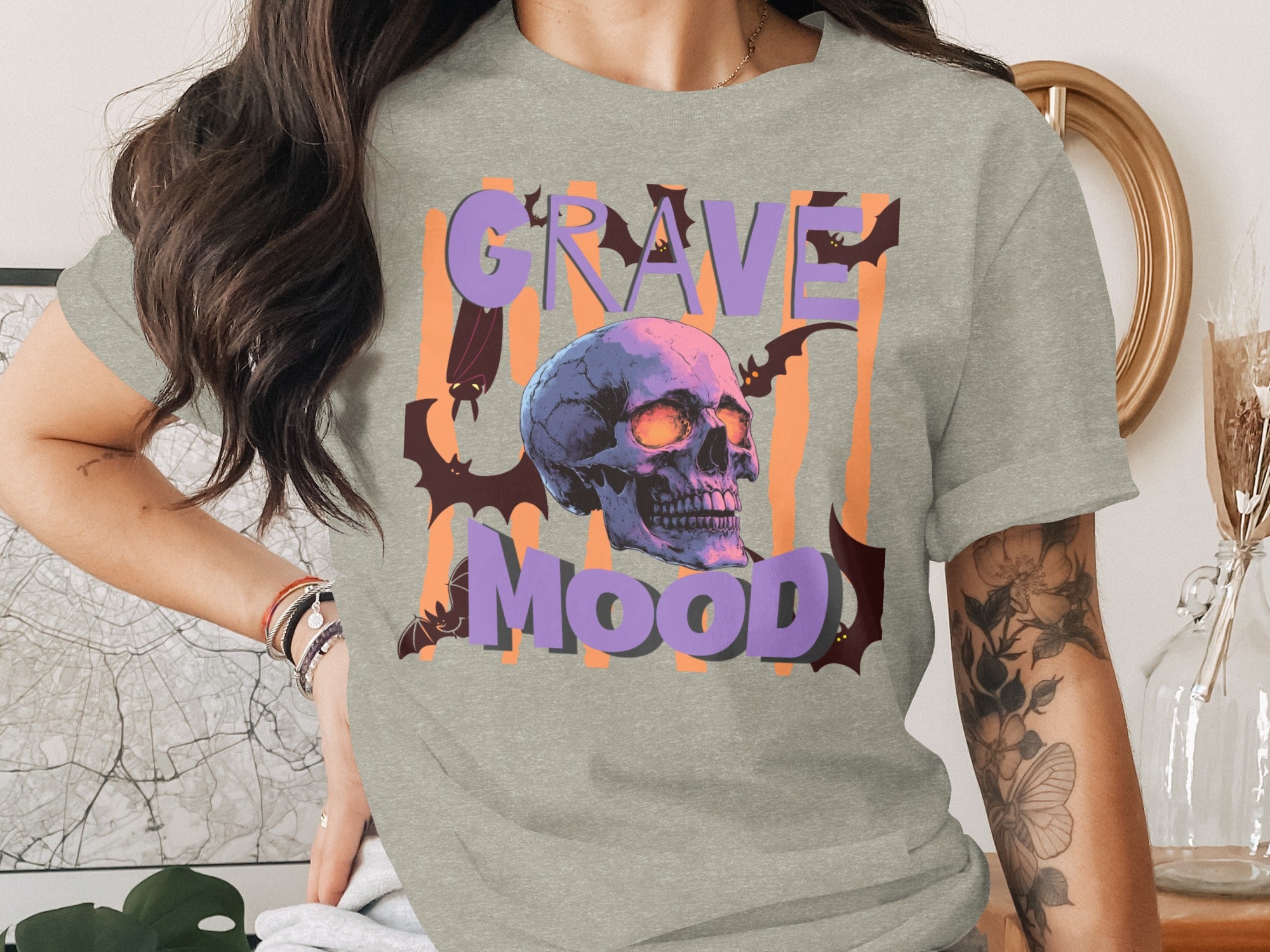Gray t-shirt with a skull, bats, and "Grave Mood" text in purple and orange.