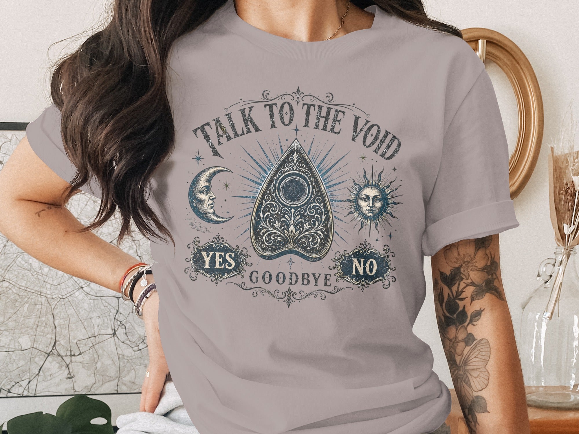 Shirt with "Talk to the Void" text and Ouija board design with moon and sun.