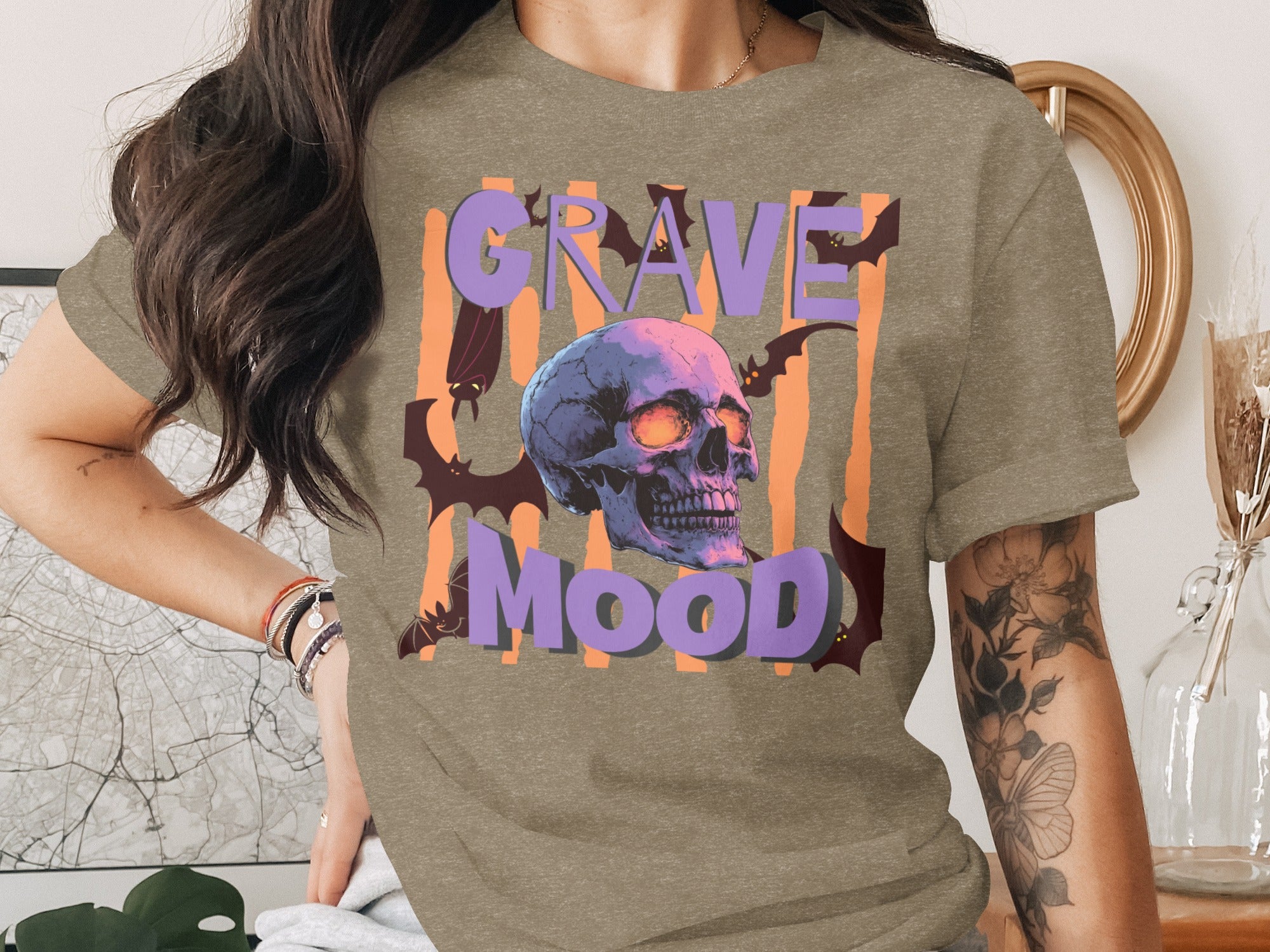 T-shirt with "Grave Mood" text, a skull, and bats on an orange striped background.