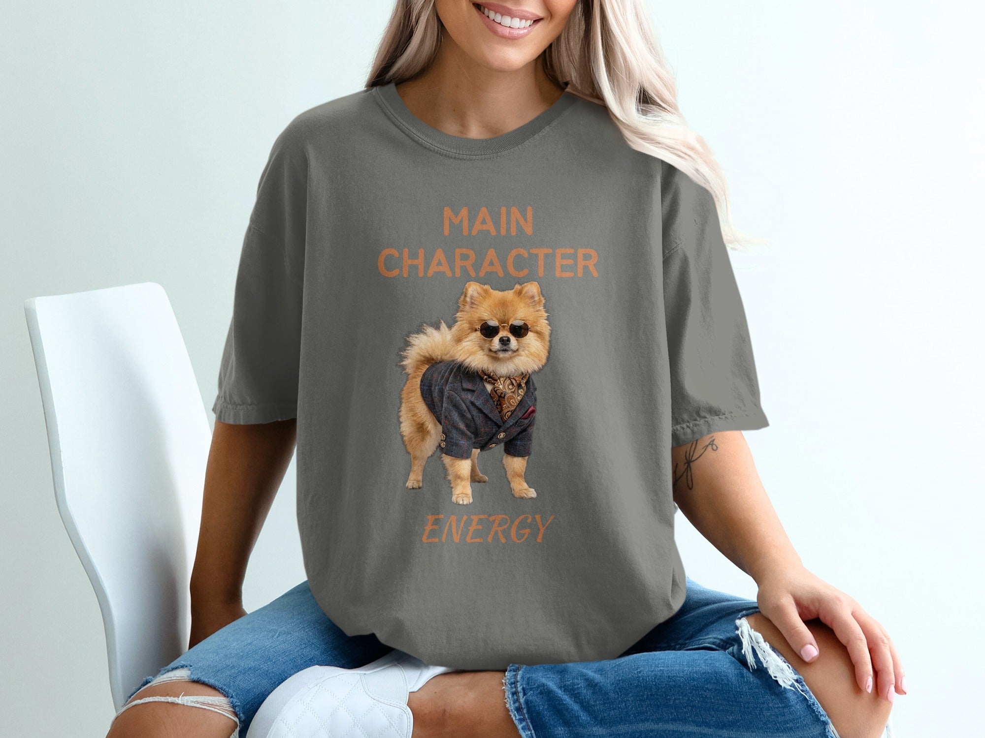 Pomeranian wearing a suit and sunglasses, text "MAIN CHARACTER ENERGY"