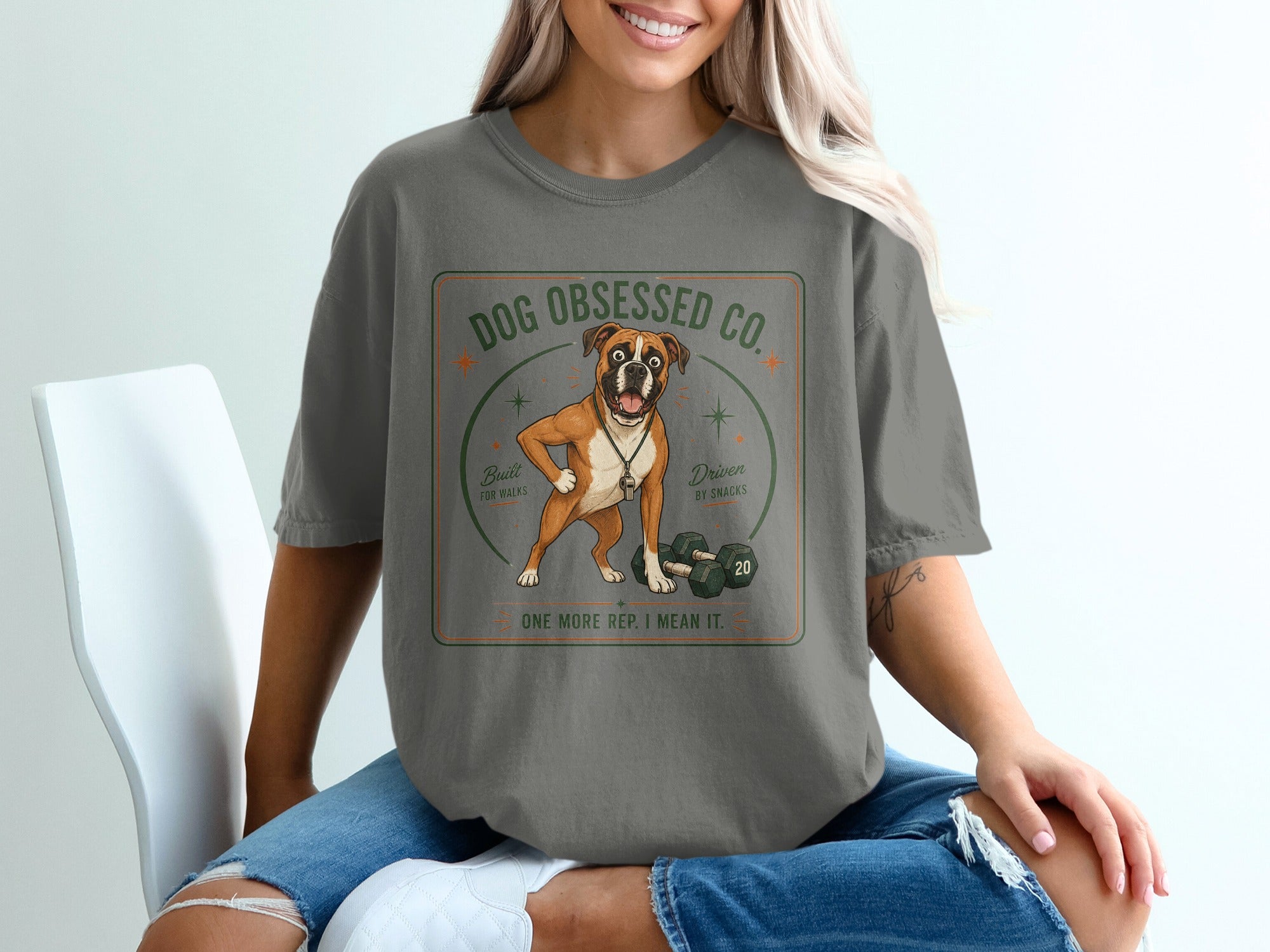 Boxer dog wearing whistle, with dumbbells and text "Dog Obsessed Co." and "One More Rep. I Mean It."