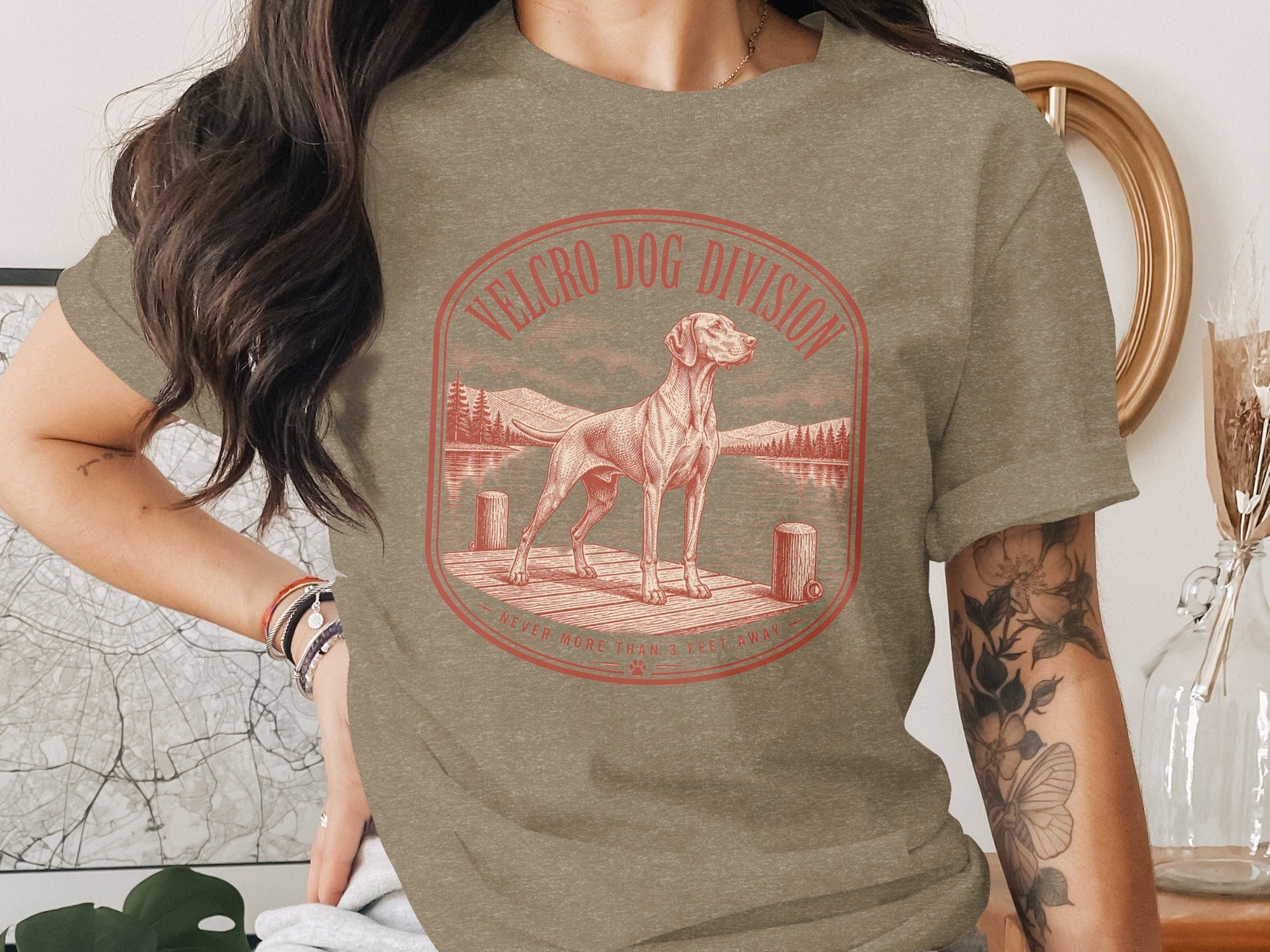 Vintage style t-shirt graphic with dog on a dock and text "Velcro Dog Division."