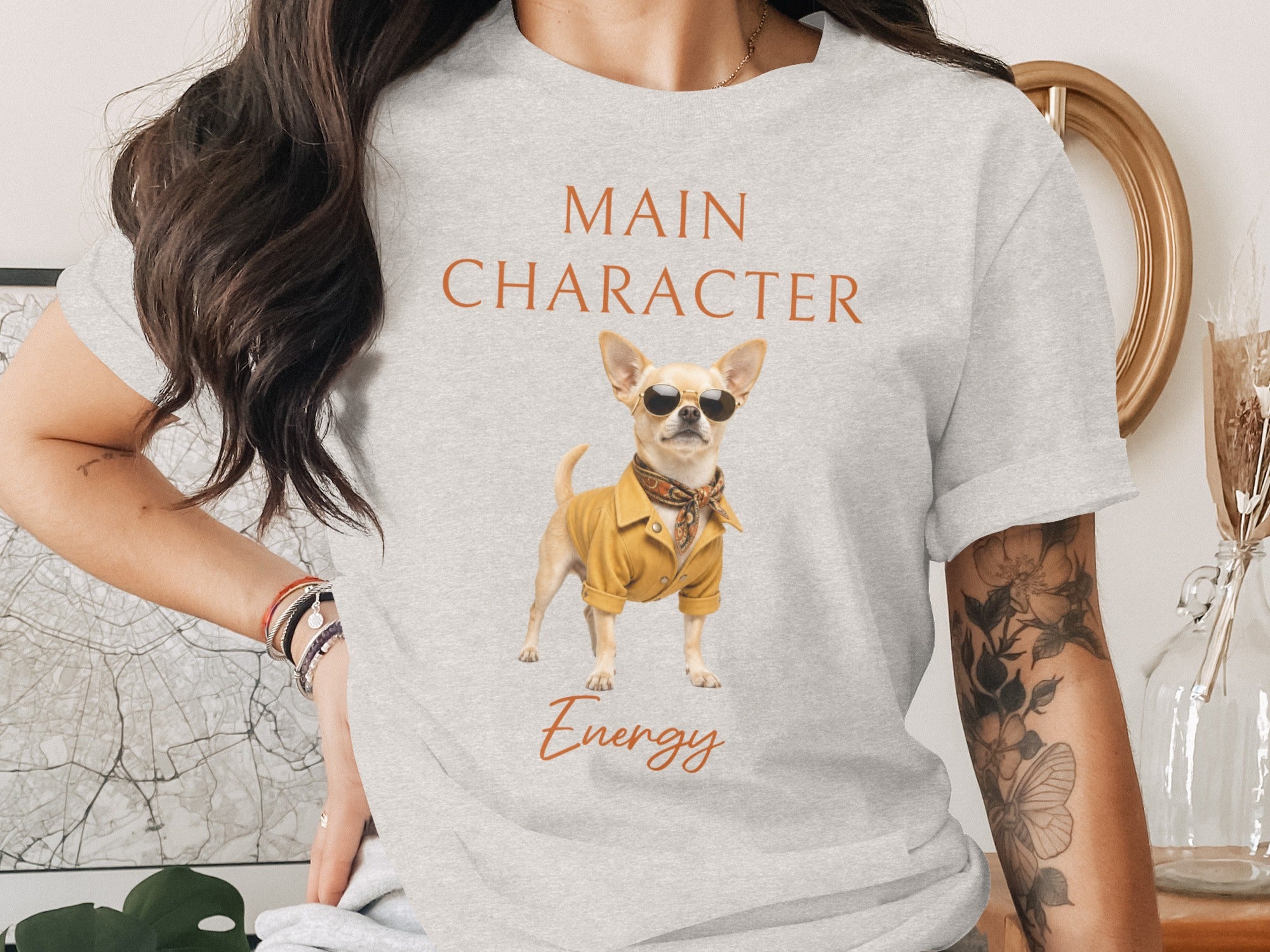 Grey t-shirt with "Main Character" and "Energy" text, featuring a chihuahua wearing sunglasses and a yellow jacket.