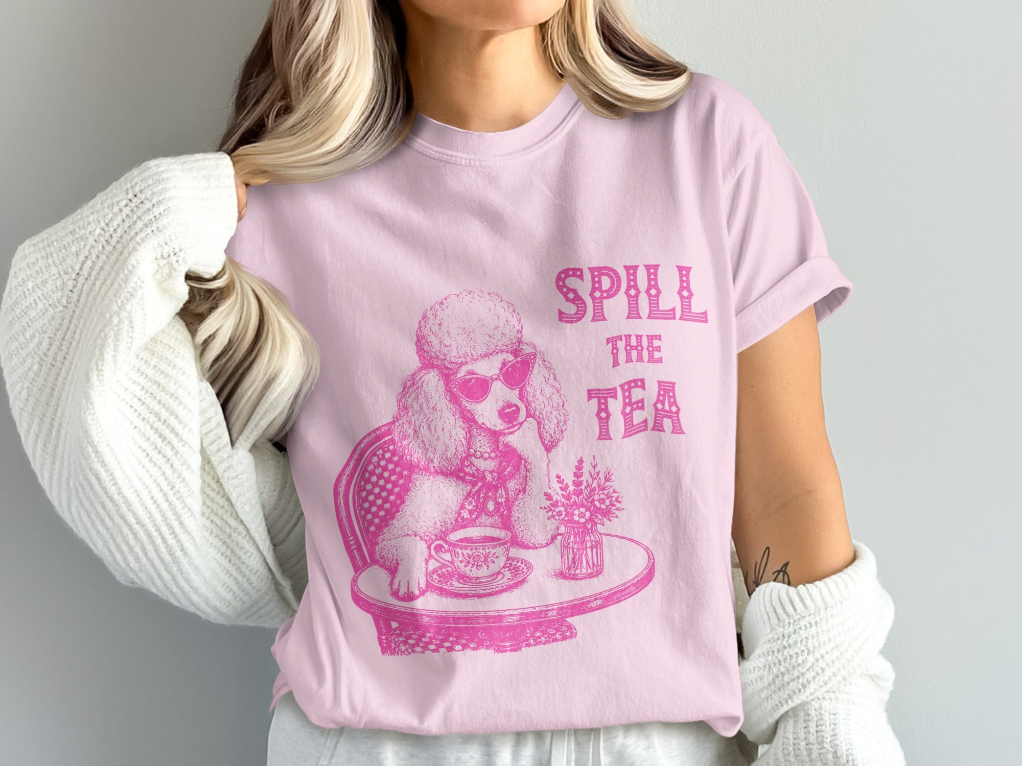 Pink t-shirt with a poodle wearing sunglasses and text "SPILL THE TEA."