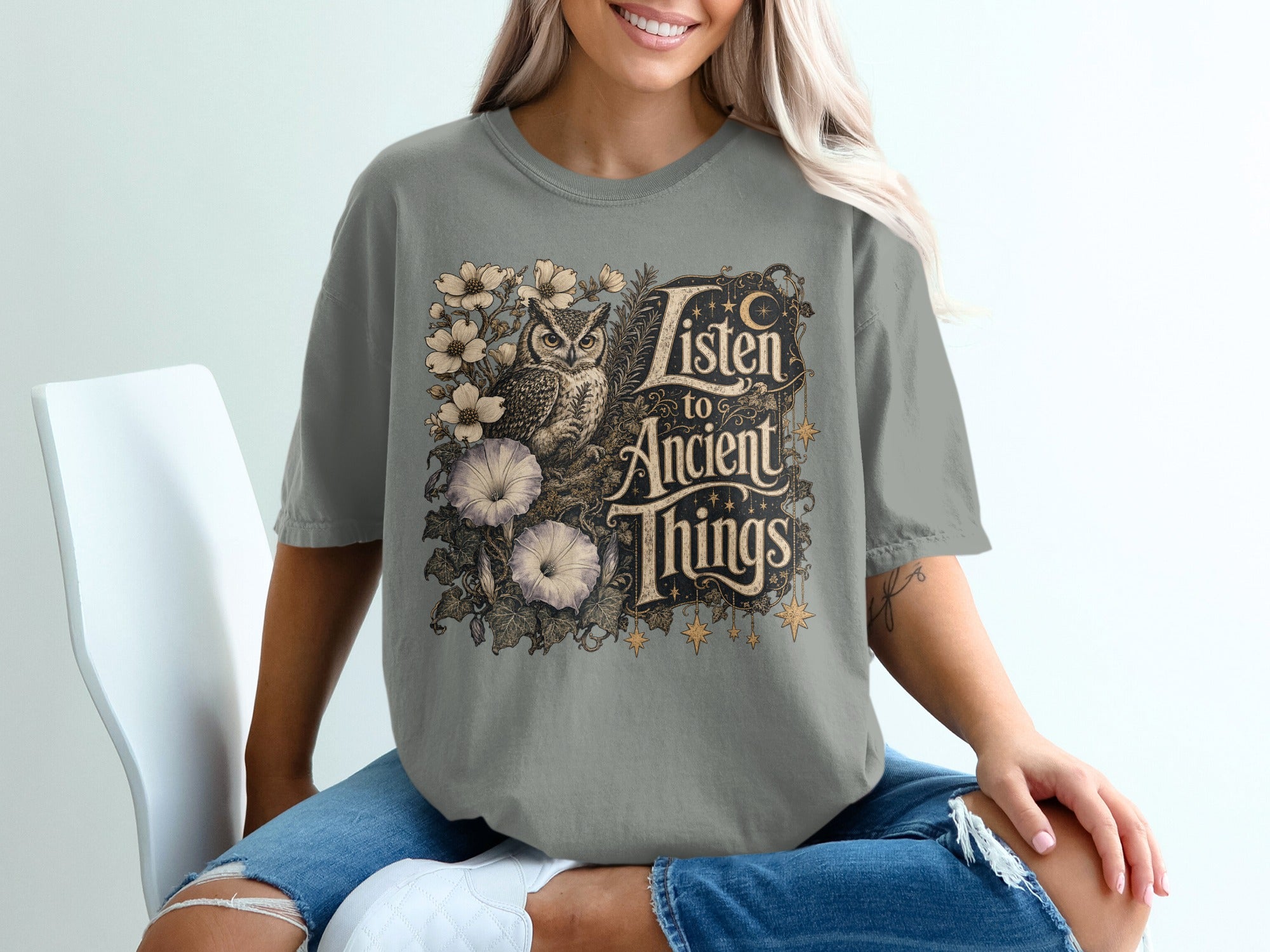 T-shirt with an owl, flowers, and text reading "Listen to Ancient Things".