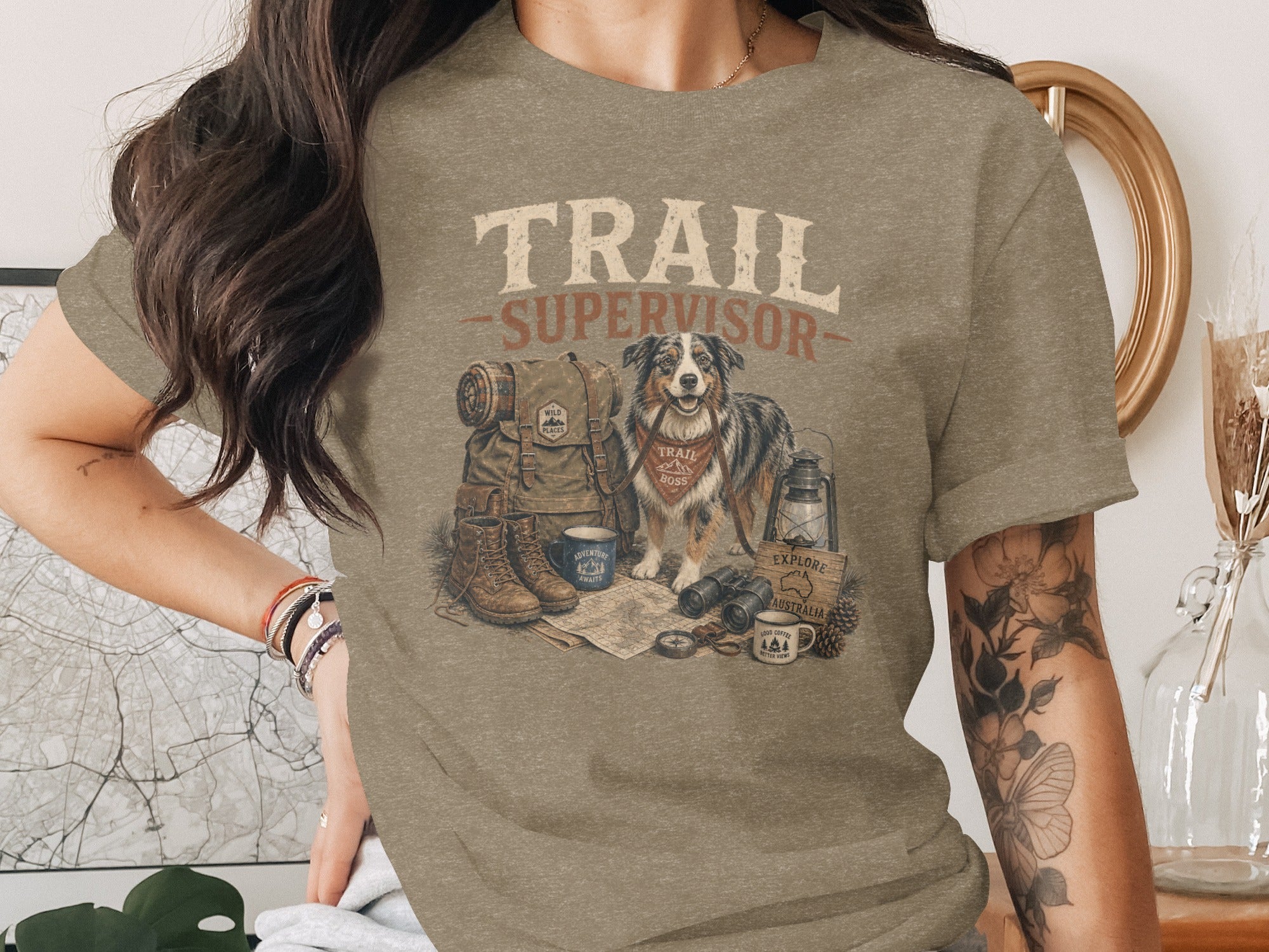 T-shirt with "Trail Supervisor" text, dog, and camping gear graphic.