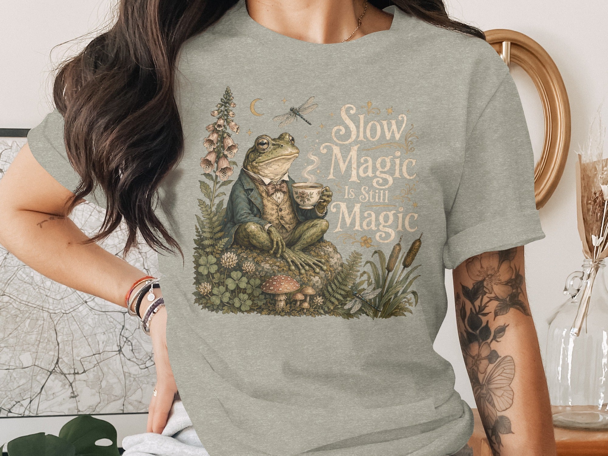 Frog in a suit drinking tea with text "Slow Magic Is Still Magic".
