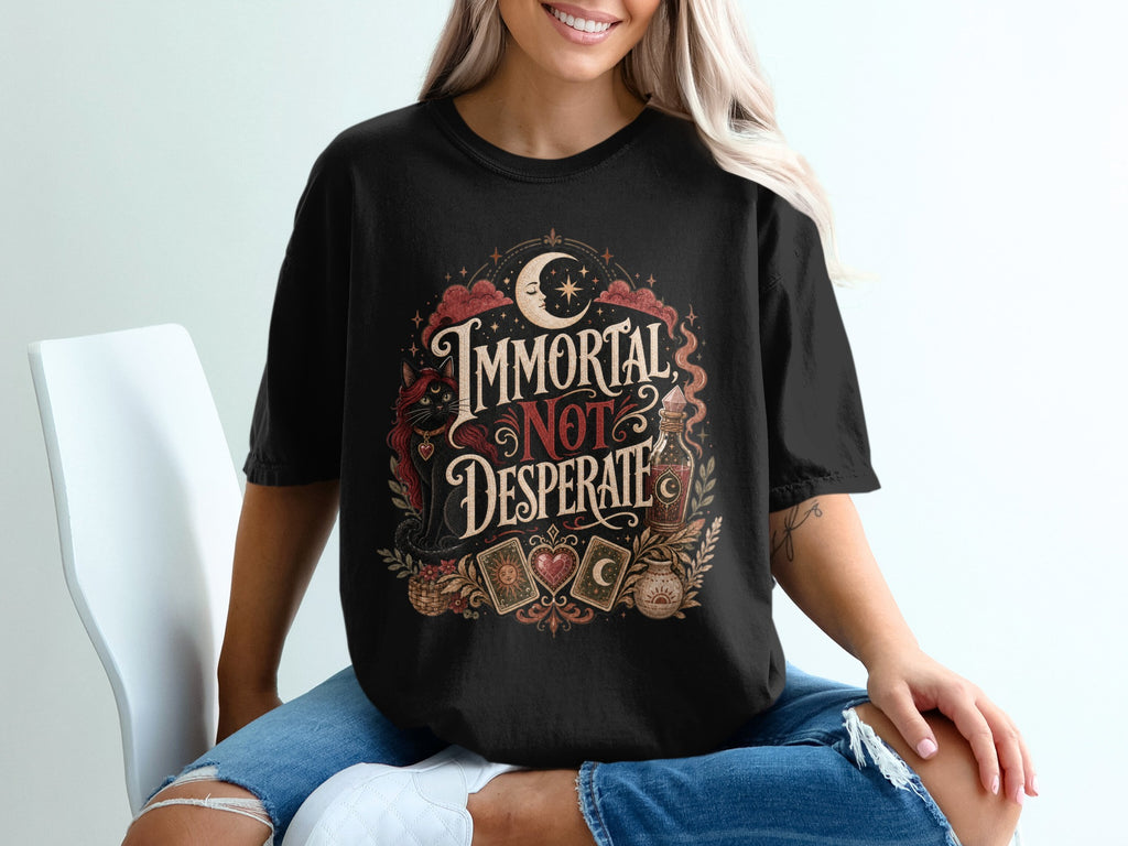 Black t-shirt with "Immortal Not Desperate" text, mystic cat, moon, and tarot cards.